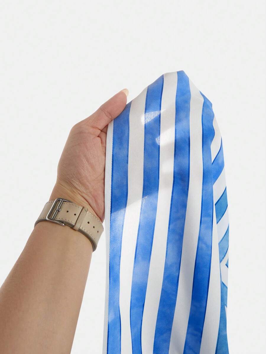 Tween girls blue striped summer camisole dress featuring spaghetti straps, high waist, flared hem, and back zipper detail.