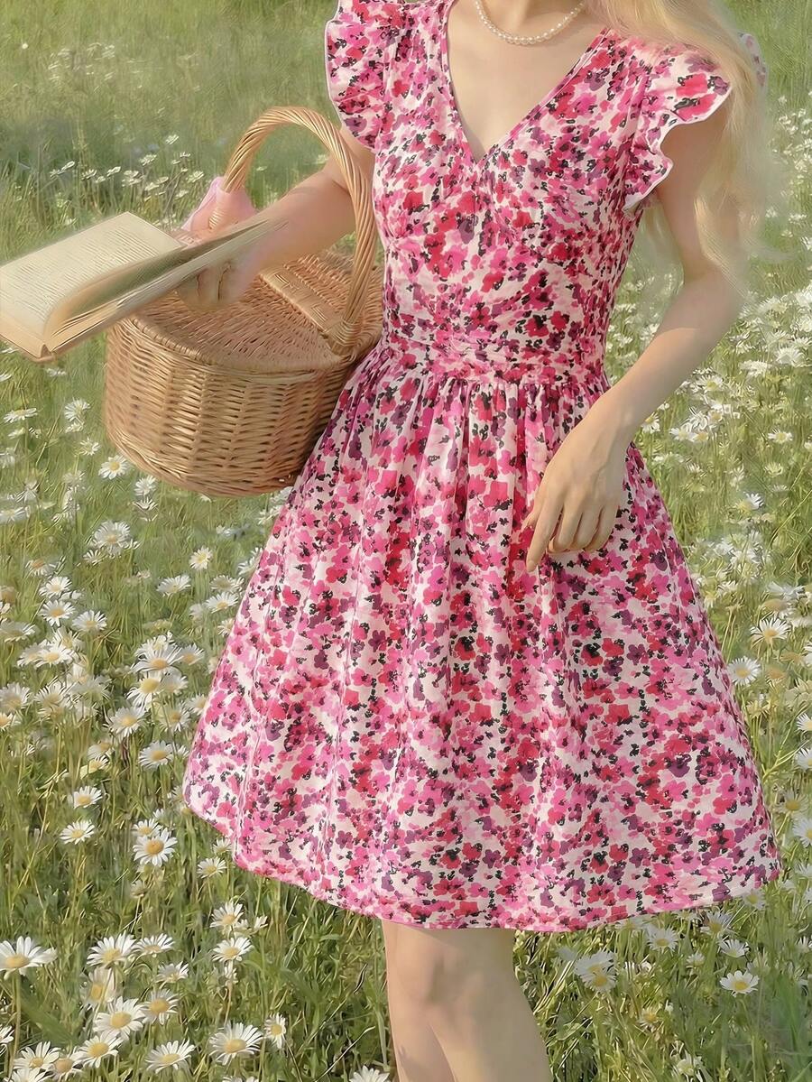 Tween girl wearing a black ditsy floral A-line short dress with V-neckline and flounce short sleeves.