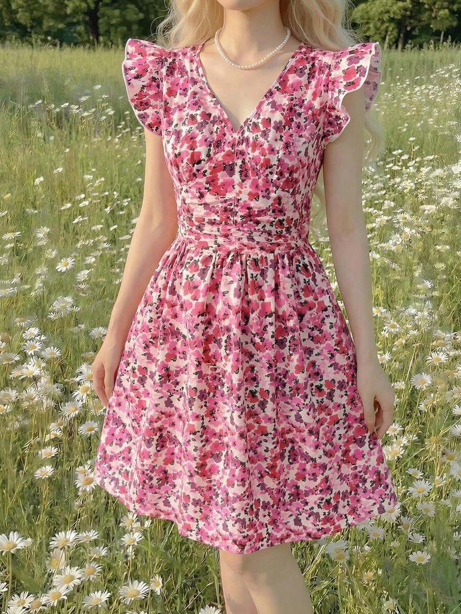 Tween girl wearing a black ditsy floral A-line short dress with V-neckline and flounce short sleeves.