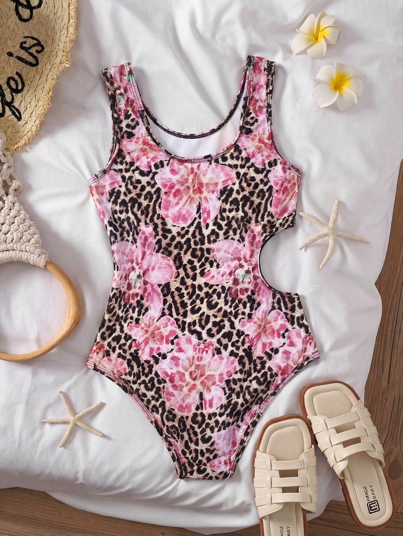 Tween girls' black and white one-piece swimsuit with striped patchwork design, scoop neck, asymmetrical cut-out detail, and fitted vacation swimwear style.