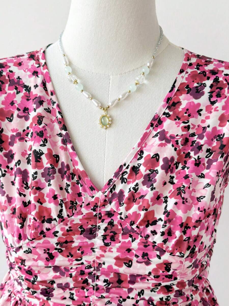 Tween girl wearing a black ditsy floral A-line short dress with V-neckline and flounce short sleeves.