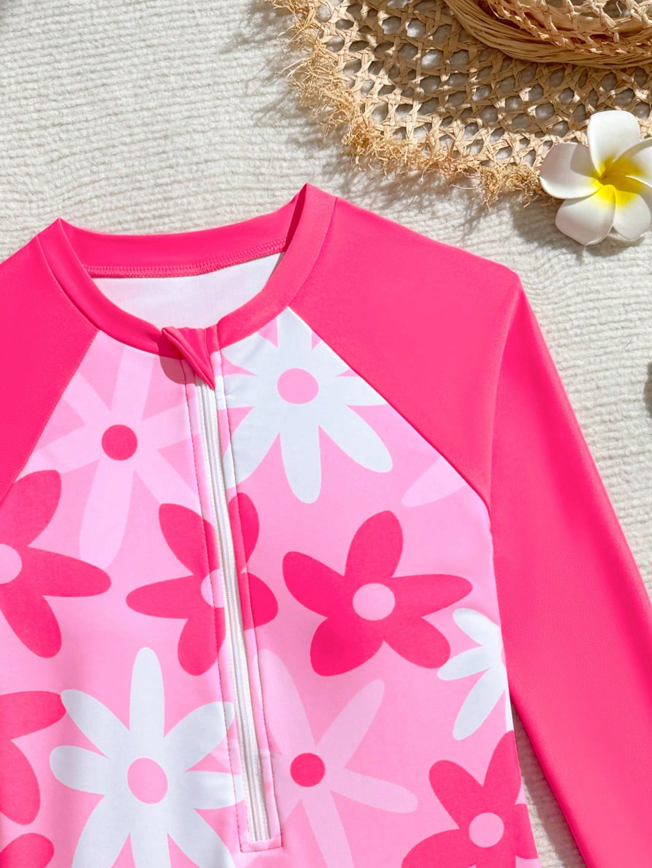 Tween girls one-piece swimsuit featuring a high neck, long sleeves, and shorts bottom, with a back zipper and strawberry plaid digital print on stretch knit fabric. Designed for swimming, vacation, and summer wear.