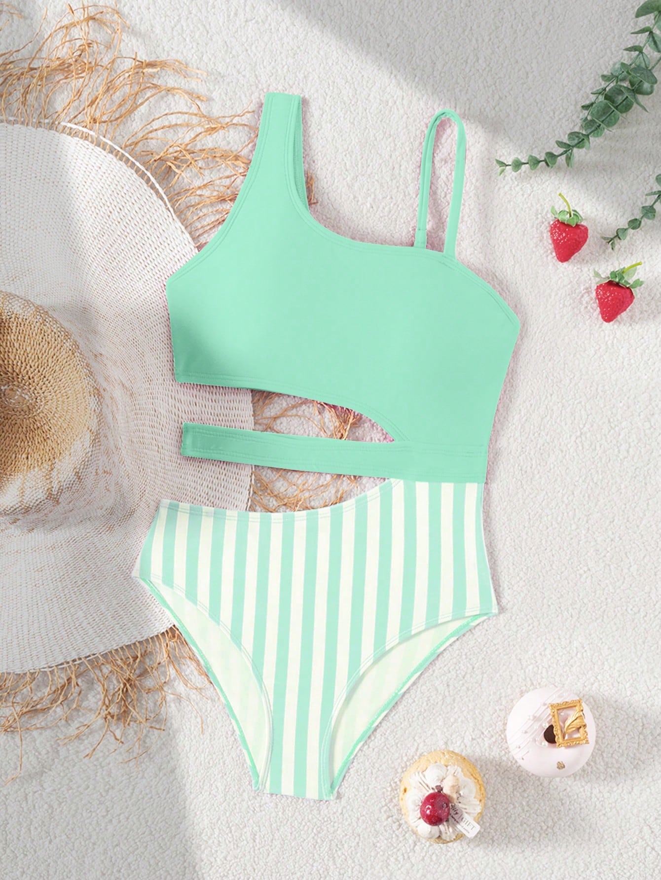 Purple tween girls one-piece swimsuit with asymmetrical neckline, cut-out waist, striped pattern, fitted silhouette, and lined body.