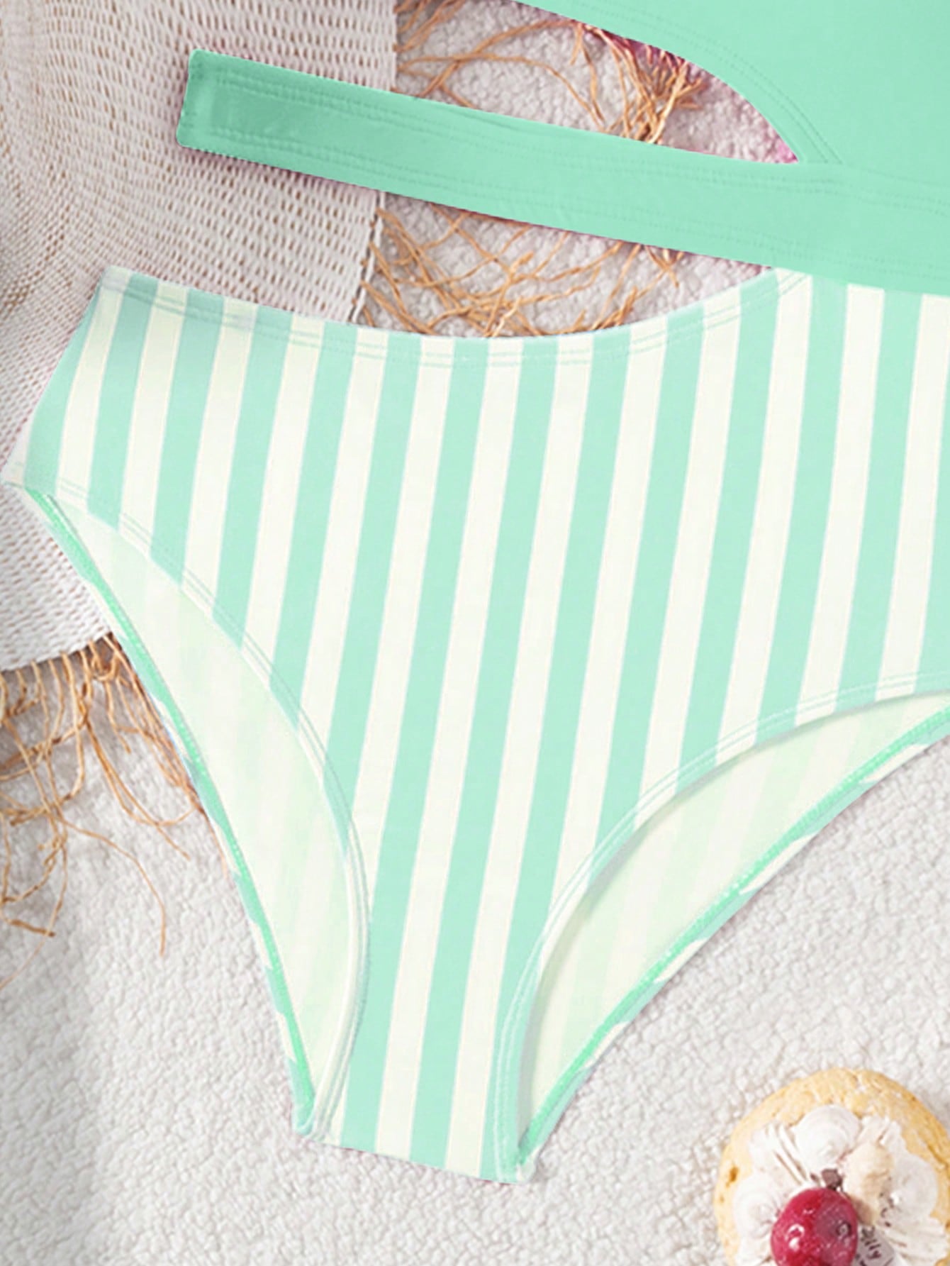 Purple tween girls one-piece swimsuit with asymmetrical neckline, cut-out waist, striped pattern, fitted silhouette, and lined body.