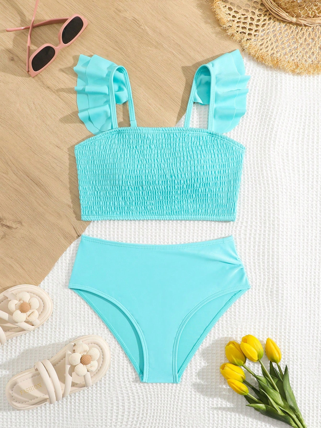 Tween girls tankini swimwear set with a solid color cap sleeve top featuring strap neckline and ruffle detail, paired with triangle-style briefs in a high-waist to mid-waist fit; two-piece vacation swim set.