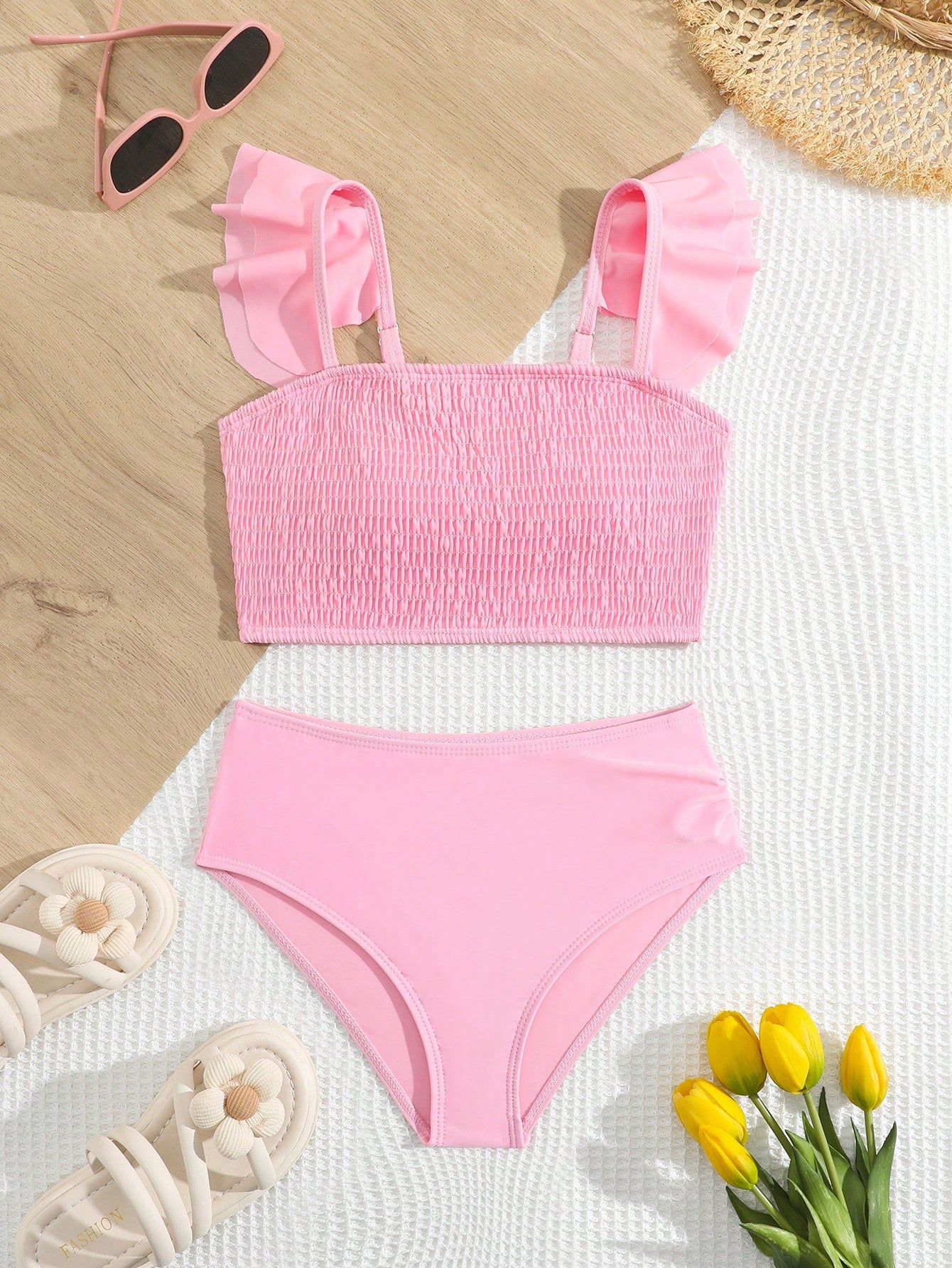 Tween girls tankini swimwear set with a solid color cap sleeve top featuring strap neckline and ruffle detail, paired with triangle-style briefs in a high-waist to mid-waist fit; two-piece vacation swim set.