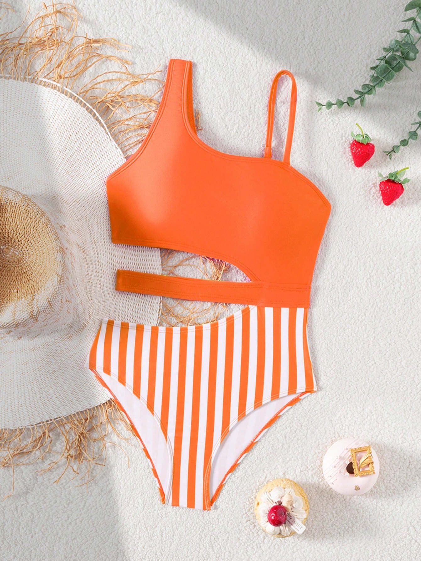 Purple tween girls one-piece swimsuit with asymmetrical neckline, cut-out waist, striped pattern, fitted silhouette, and lined body.