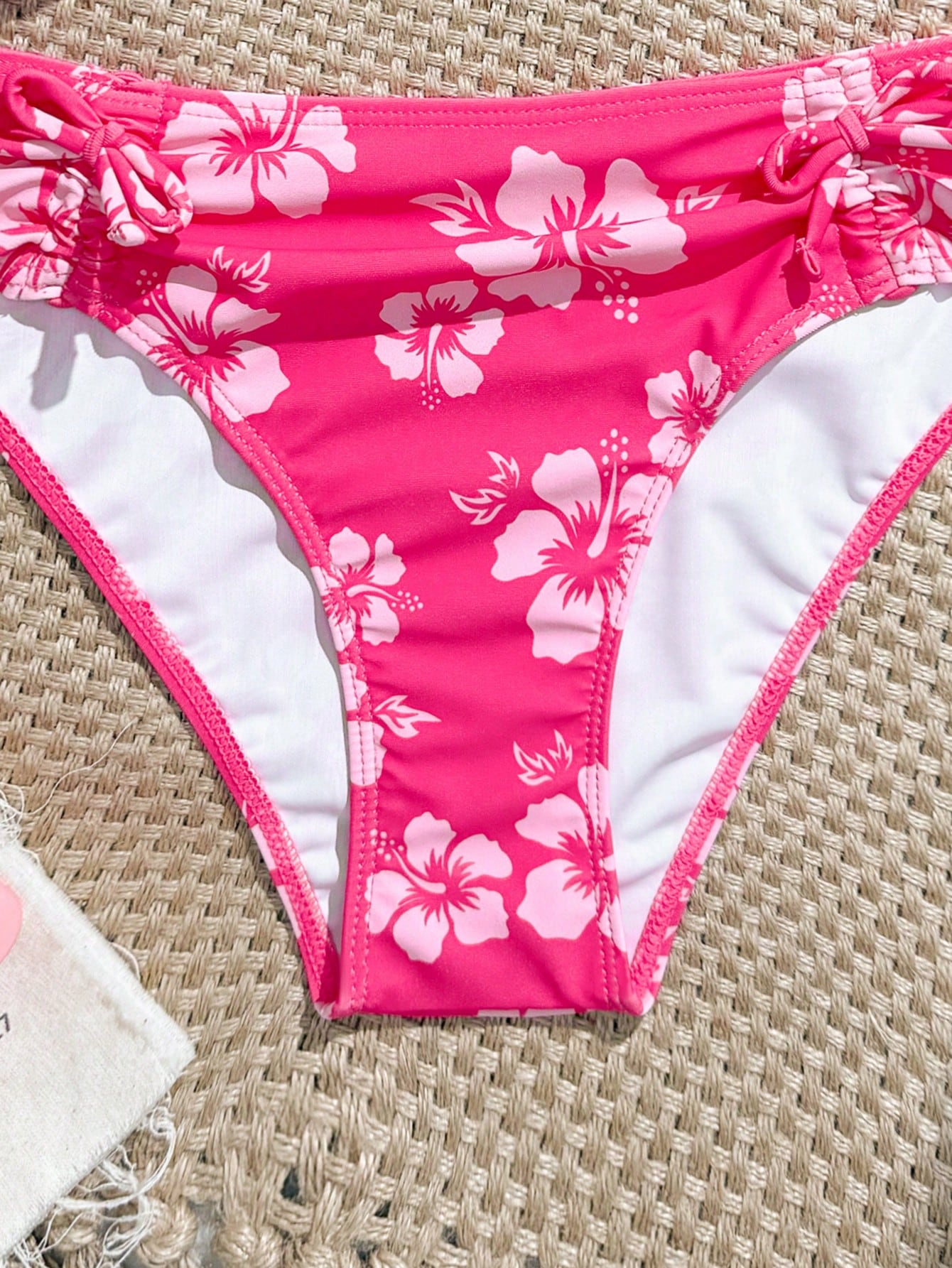 Tween girls 2-piece ditsy floral bikini set featuring a spaghetti strap top with center string detail and matching bottoms with side strings, designed for swimming, vacation, and summer wear.
