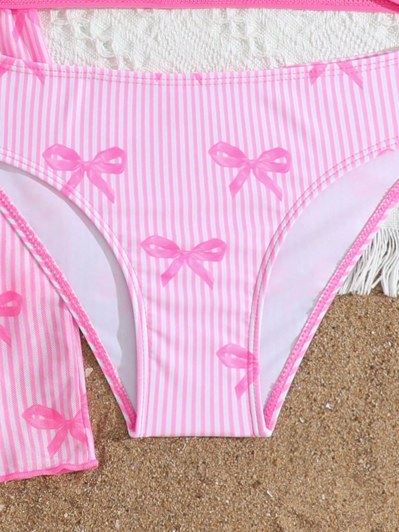 Three-piece tween girls swimwear set with a floral print, featuring a criss-cross bikini top, regular bikini bottoms, and a kimono cover-up in assorted prints.