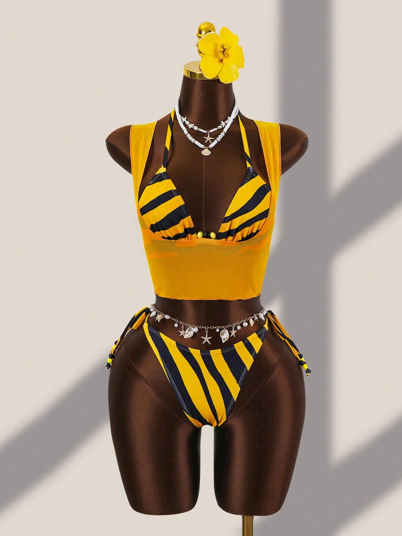 Brown striped 3-piece bikini set for women featuring a halter tie neck, wireless triangle cups with removable padding, cut-out details, and low waist tie side bottoms.