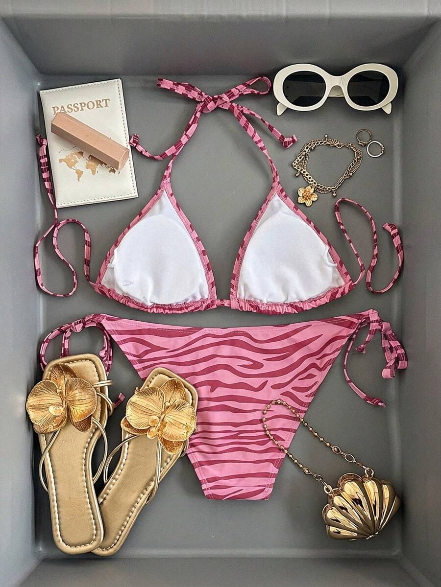 Women's black and white zebra print two-piece bikini set featuring a high waist tie-side bottom and a backless halter top with removable padding.