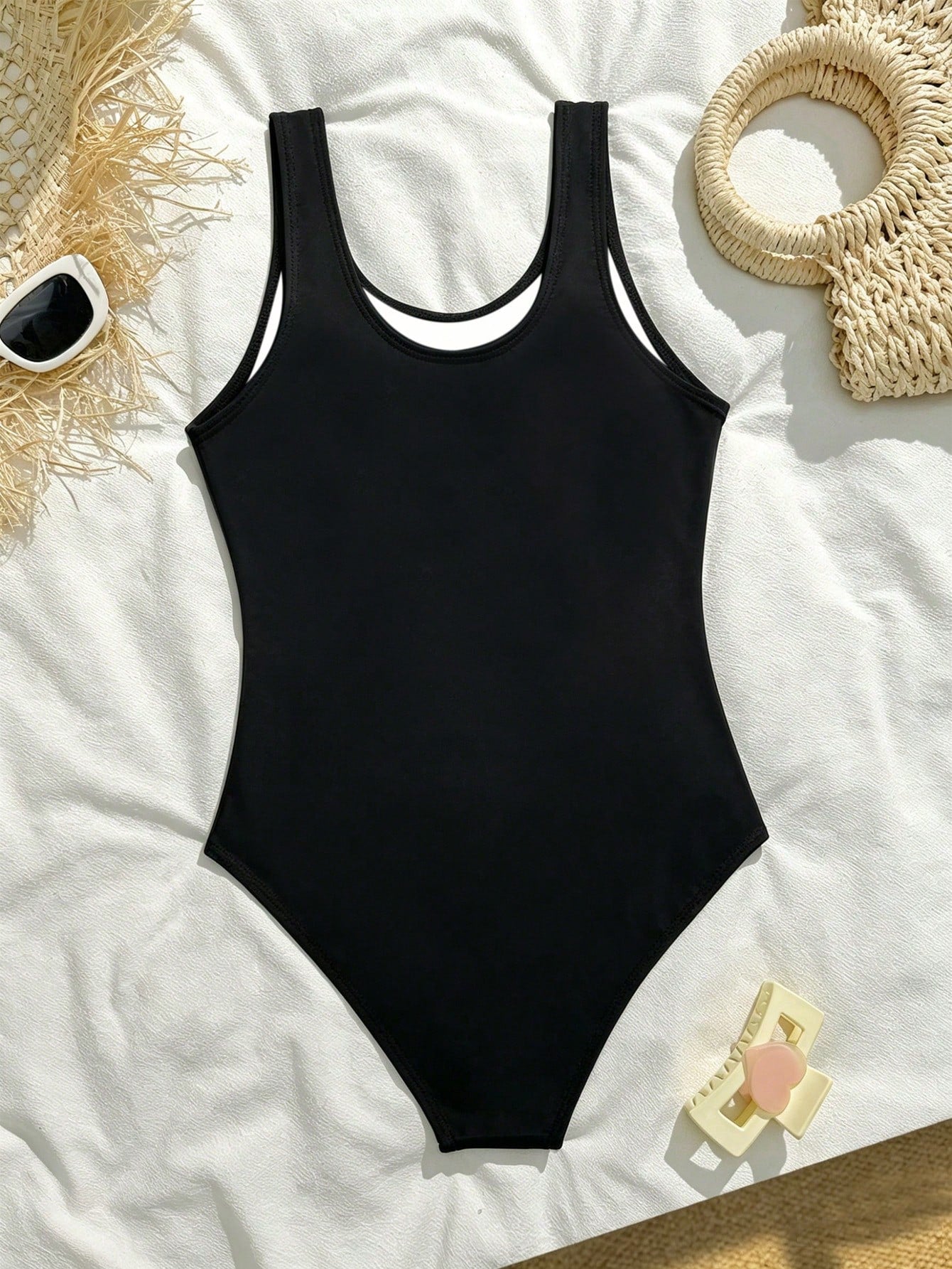 White plain camisole one-piece swimsuit for tween girls with scoop neck, fitted shape, mid-waist bottom, and wireless bra for swimming, beach, pool, or vacation wear.
