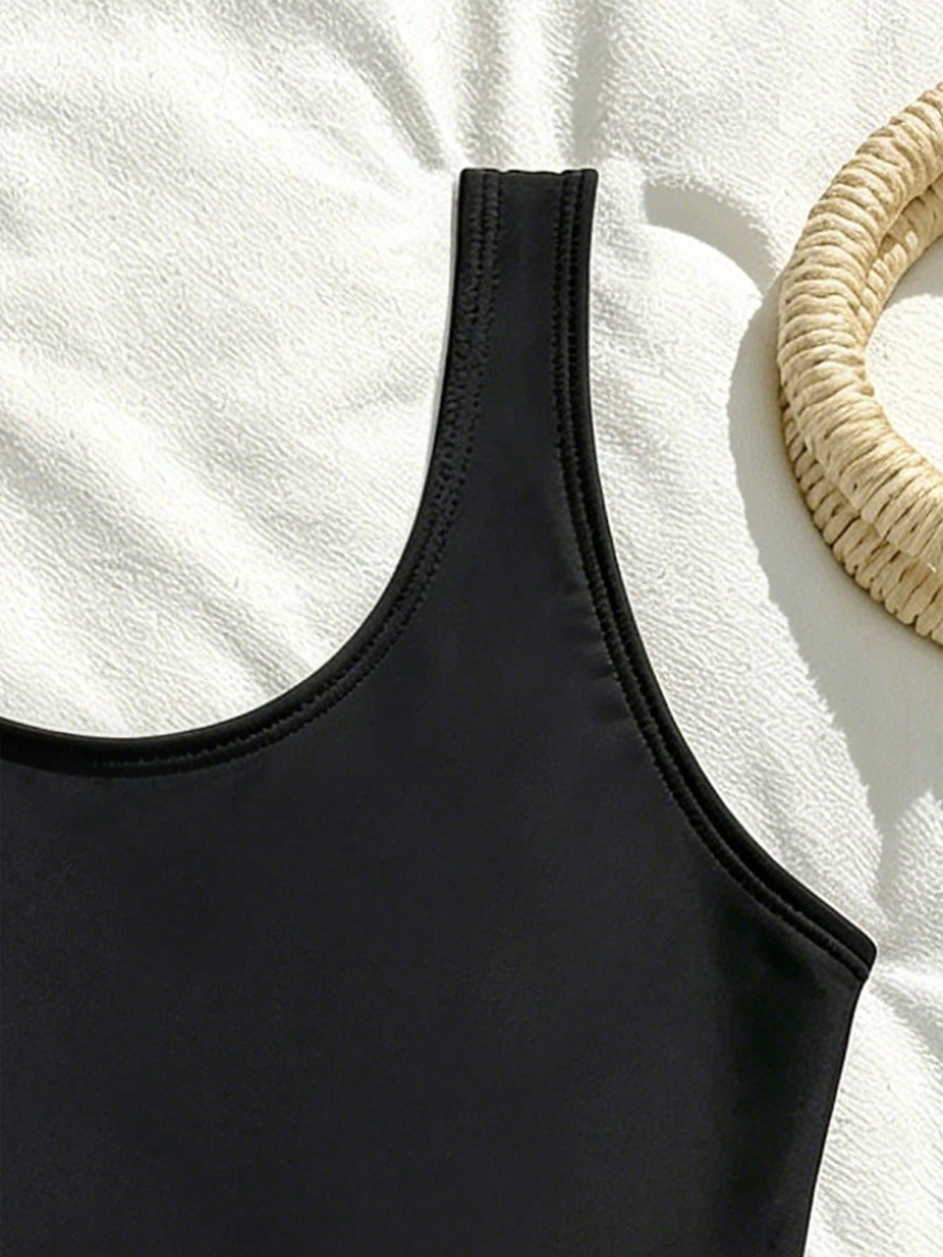White plain camisole one-piece swimsuit for tween girls with scoop neck, fitted shape, mid-waist bottom, and wireless bra for swimming, beach, pool, or vacation wear.