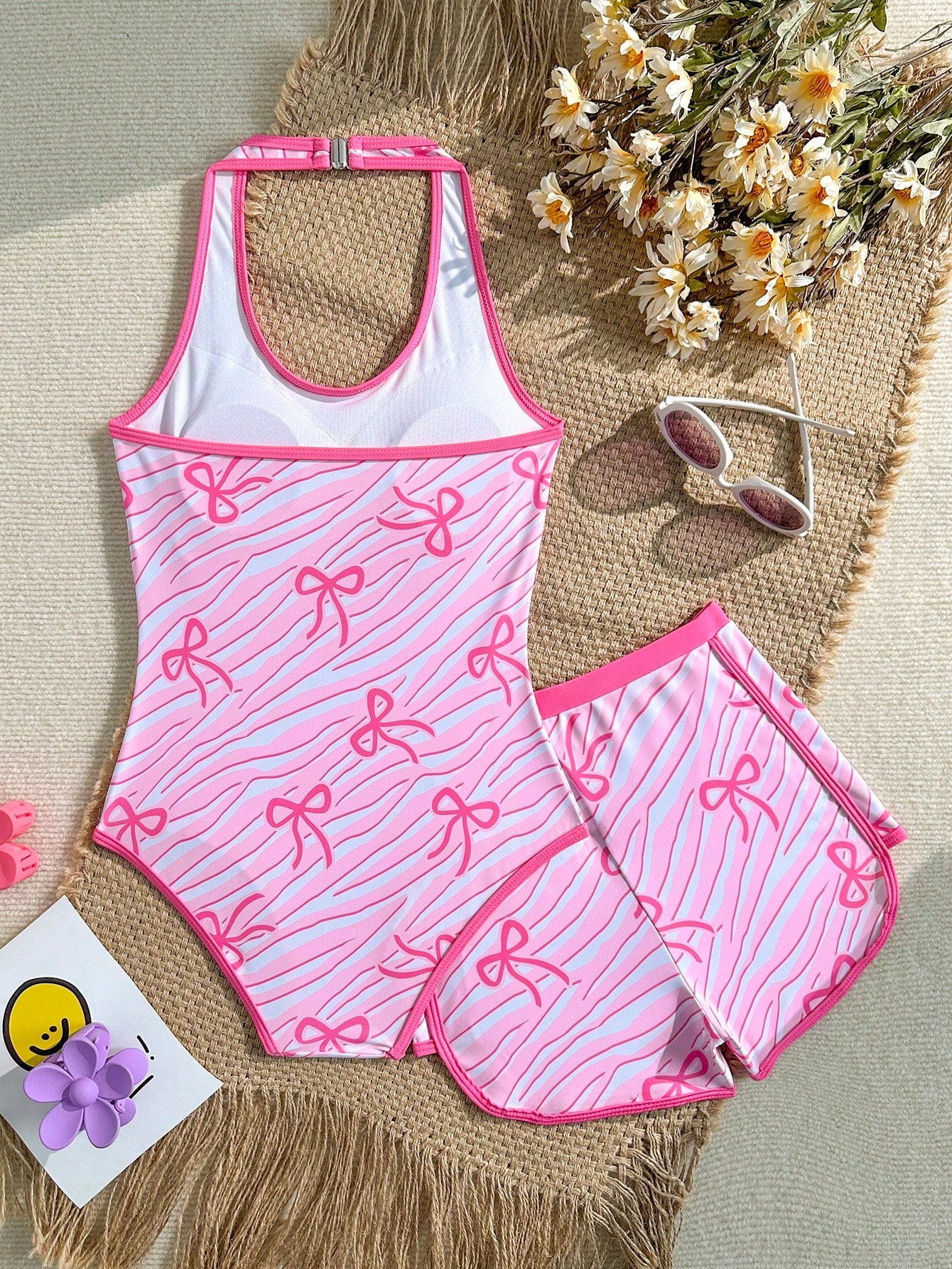 Girls 2-piece swimwear set featuring a butterfly print halter swimsuit top with contrast piping and separate mid-waist shorts; sleeveless, high-stretch, wireless design for beach and vacation wear.