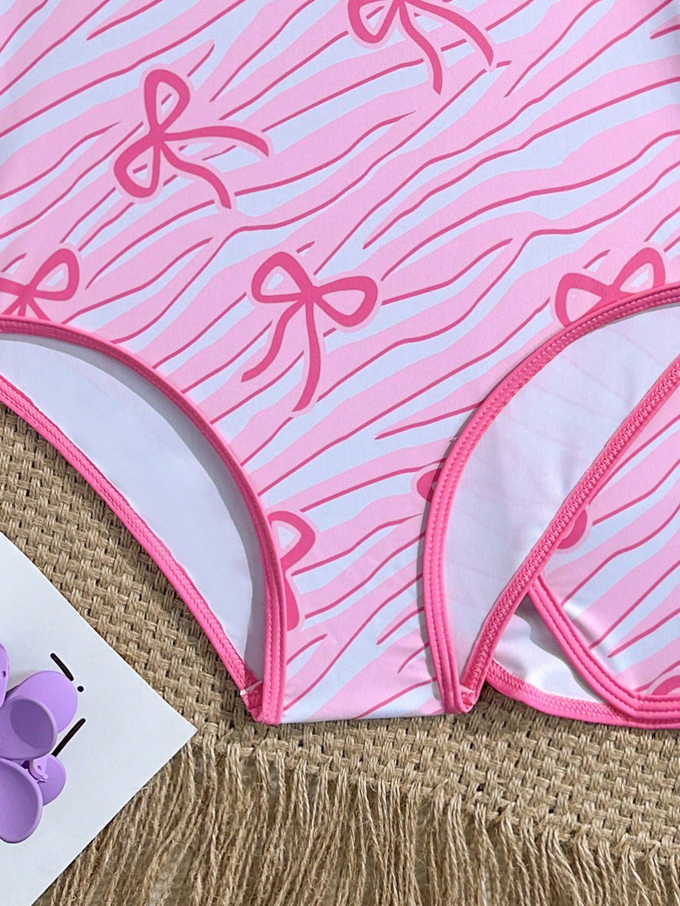 Girls 2-piece swimwear set featuring a butterfly print halter swimsuit top with contrast piping and separate mid-waist shorts; sleeveless, high-stretch, wireless design for beach and vacation wear.