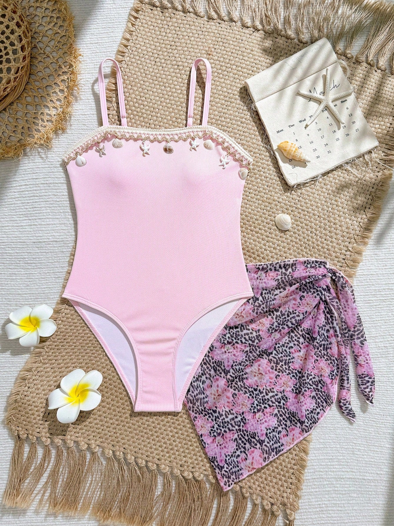 Blue girls one-piece swimsuit with spaghetti straps, textured plain fabric, shell-inspired detail, and matching skirt bottom for beach or pool vacation wear.