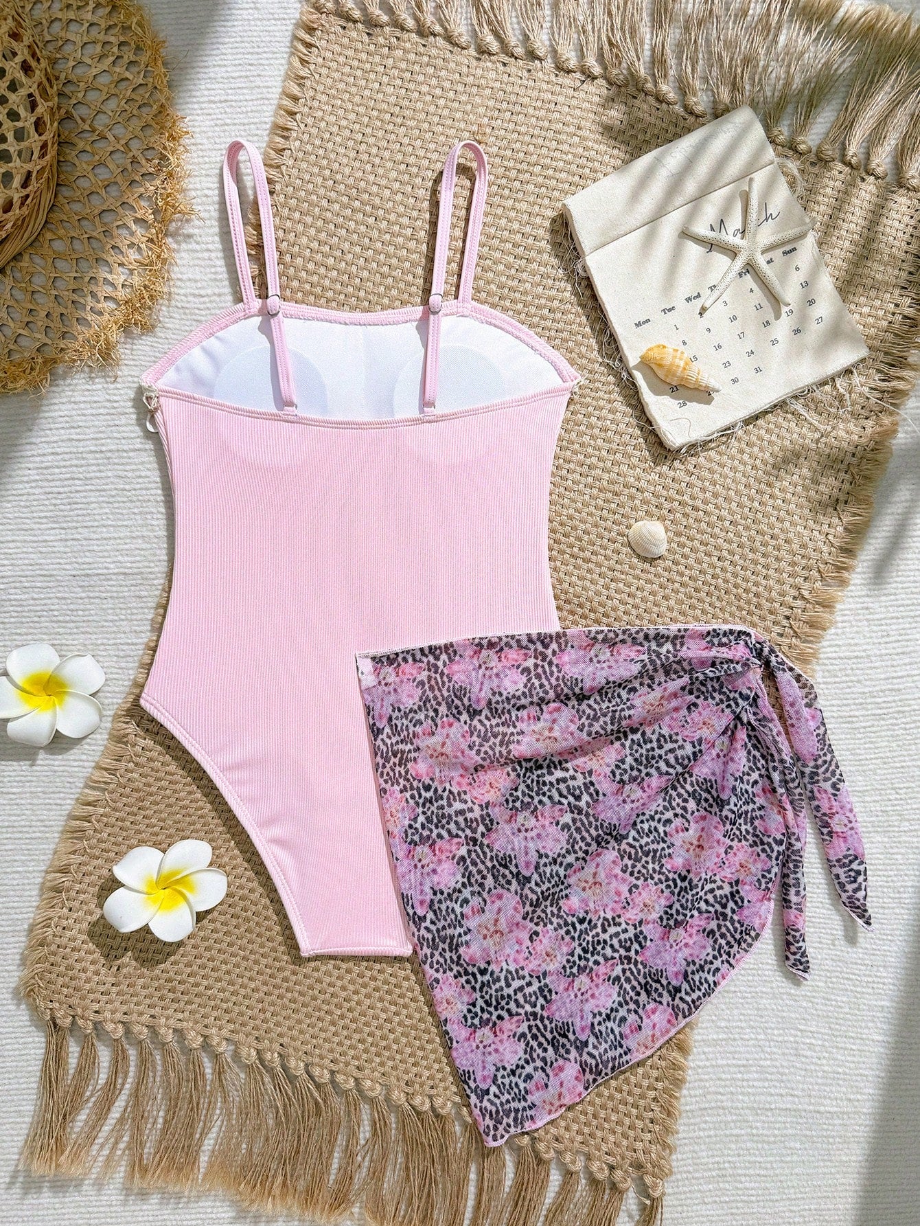 Blue girls one-piece swimsuit with spaghetti straps, textured plain fabric, shell-inspired detail, and matching skirt bottom for beach or pool vacation wear.