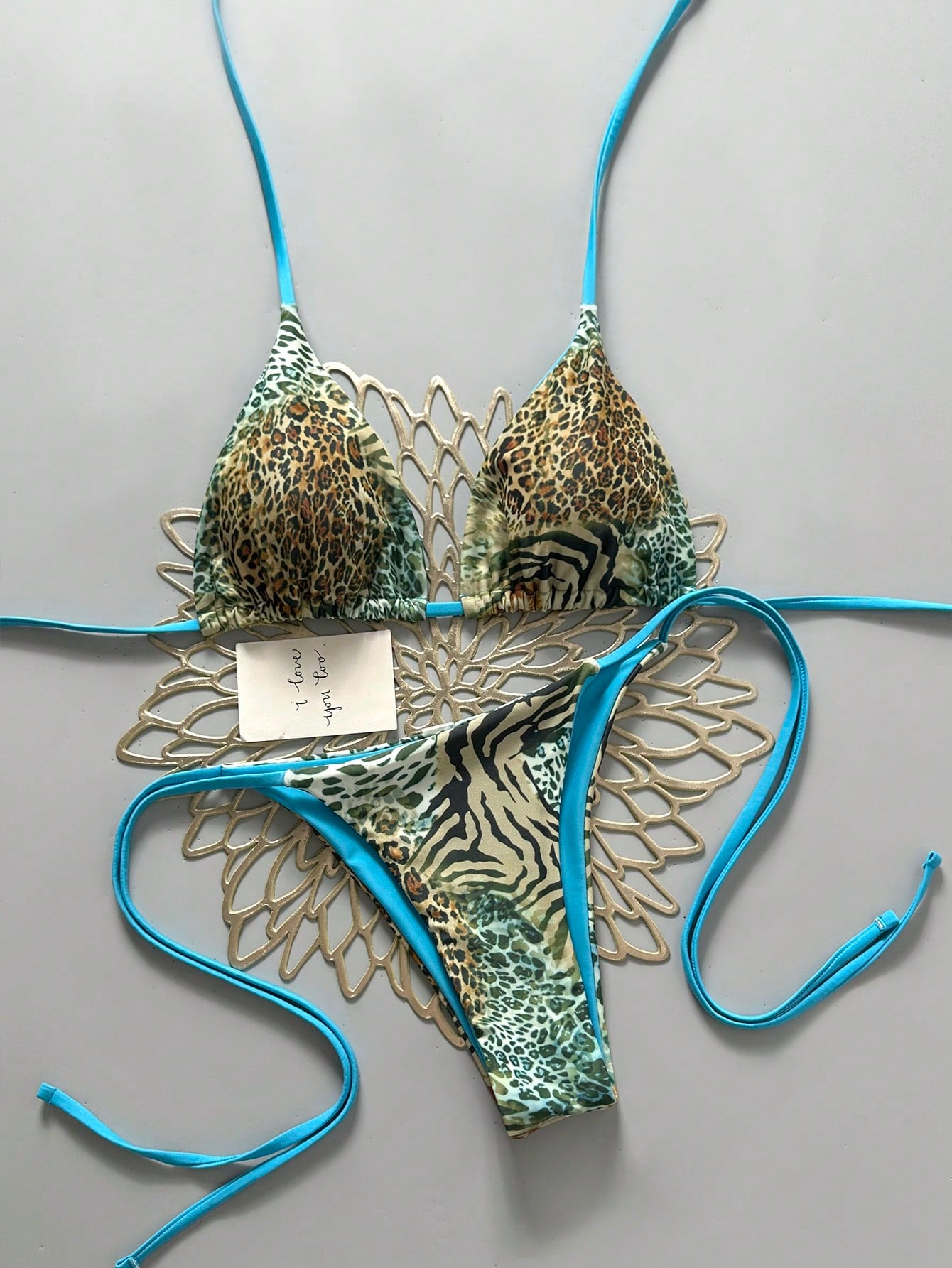 Women's vintage leopard print 2-piece bikini set featuring a high waist tie-side bottom and a halter neck triangle top.