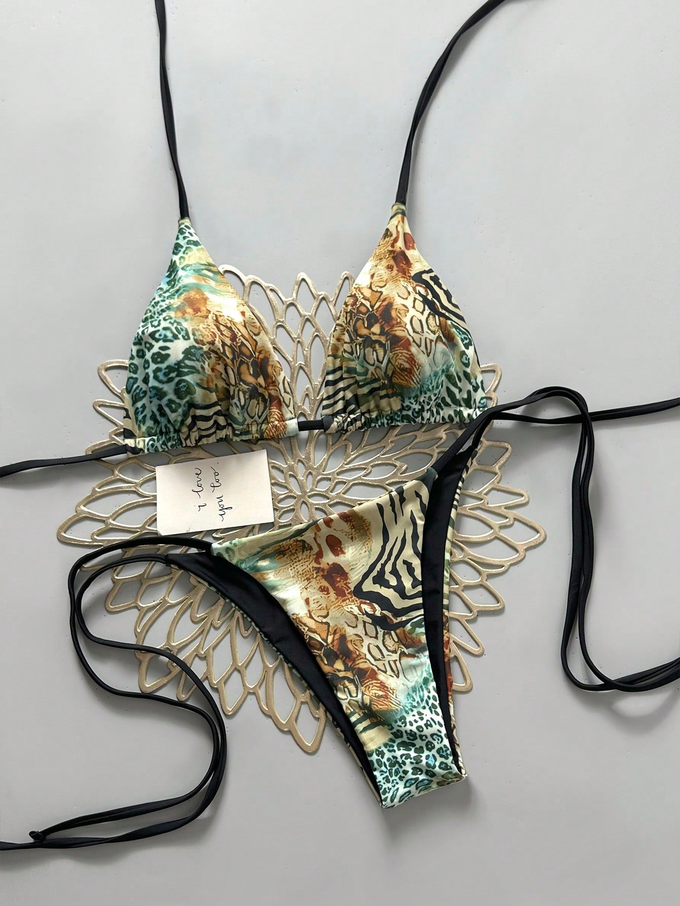 Women's vintage leopard print 2-piece bikini set featuring a high waist tie-side bottom and a halter neck triangle top.