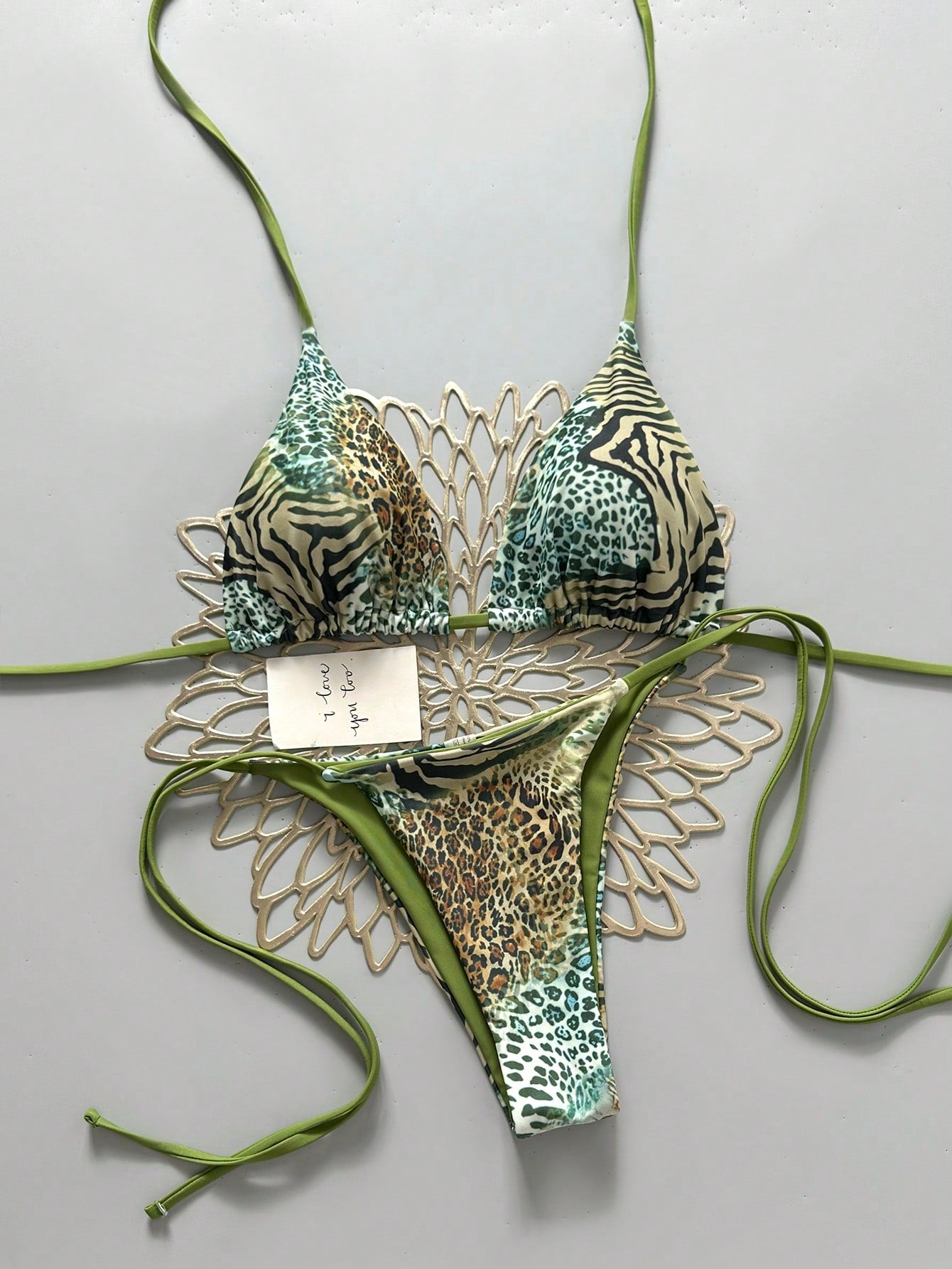 Women's vintage leopard print 2-piece bikini set featuring a high waist tie-side bottom and a halter neck triangle top.
