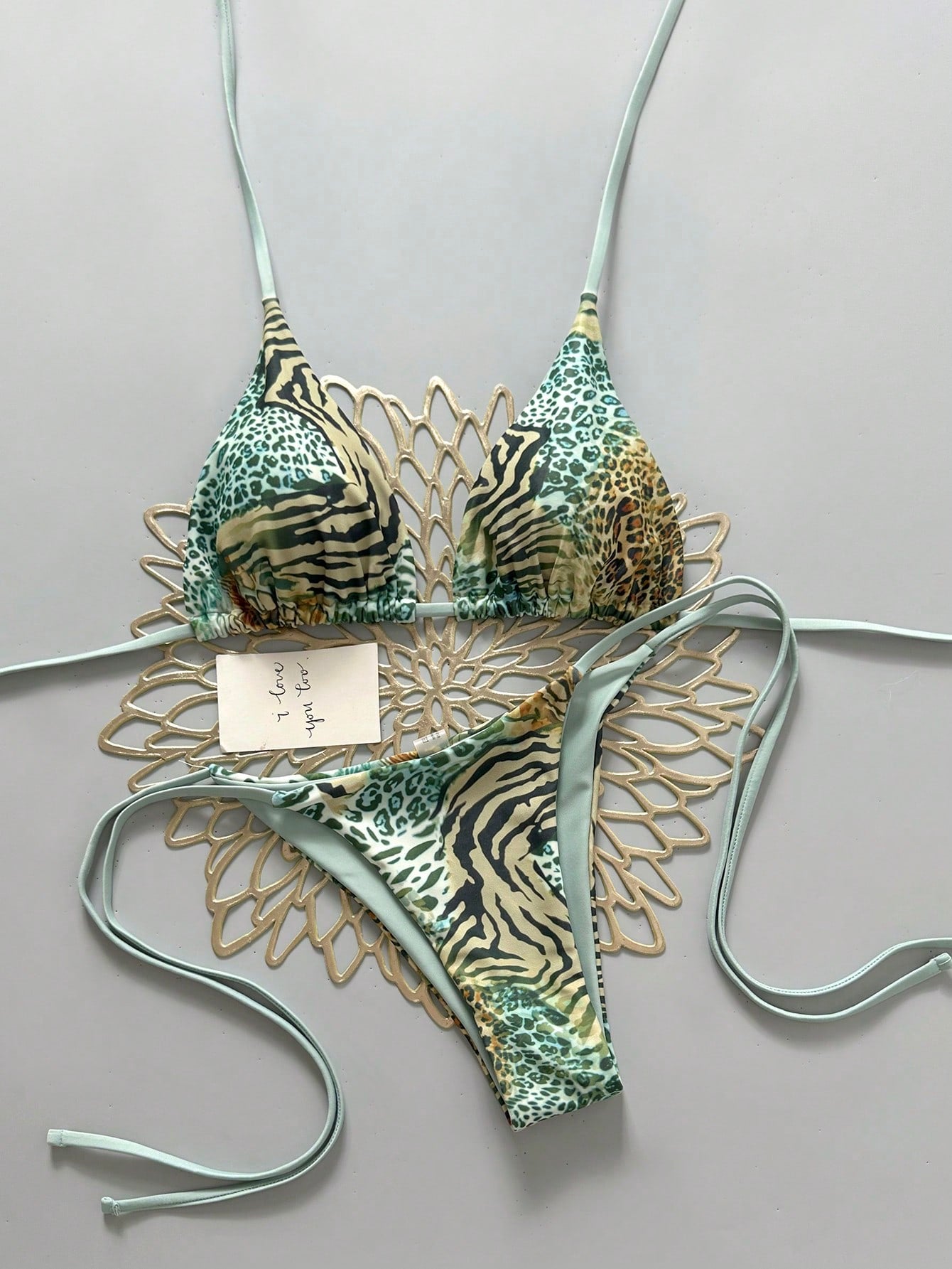 Women's vintage leopard print 2-piece bikini set featuring a high waist tie-side bottom and a halter neck triangle top.