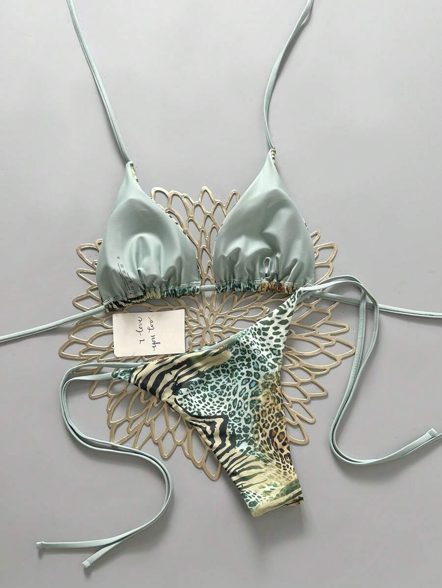Women's vintage leopard print 2-piece bikini set featuring a high waist tie-side bottom and a halter neck triangle top.