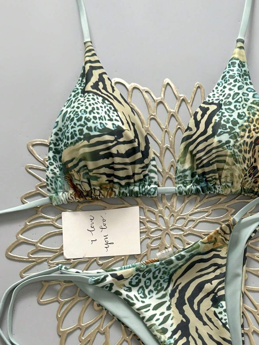 Women's vintage leopard print 2-piece bikini set featuring a high waist tie-side bottom and a halter neck triangle top.