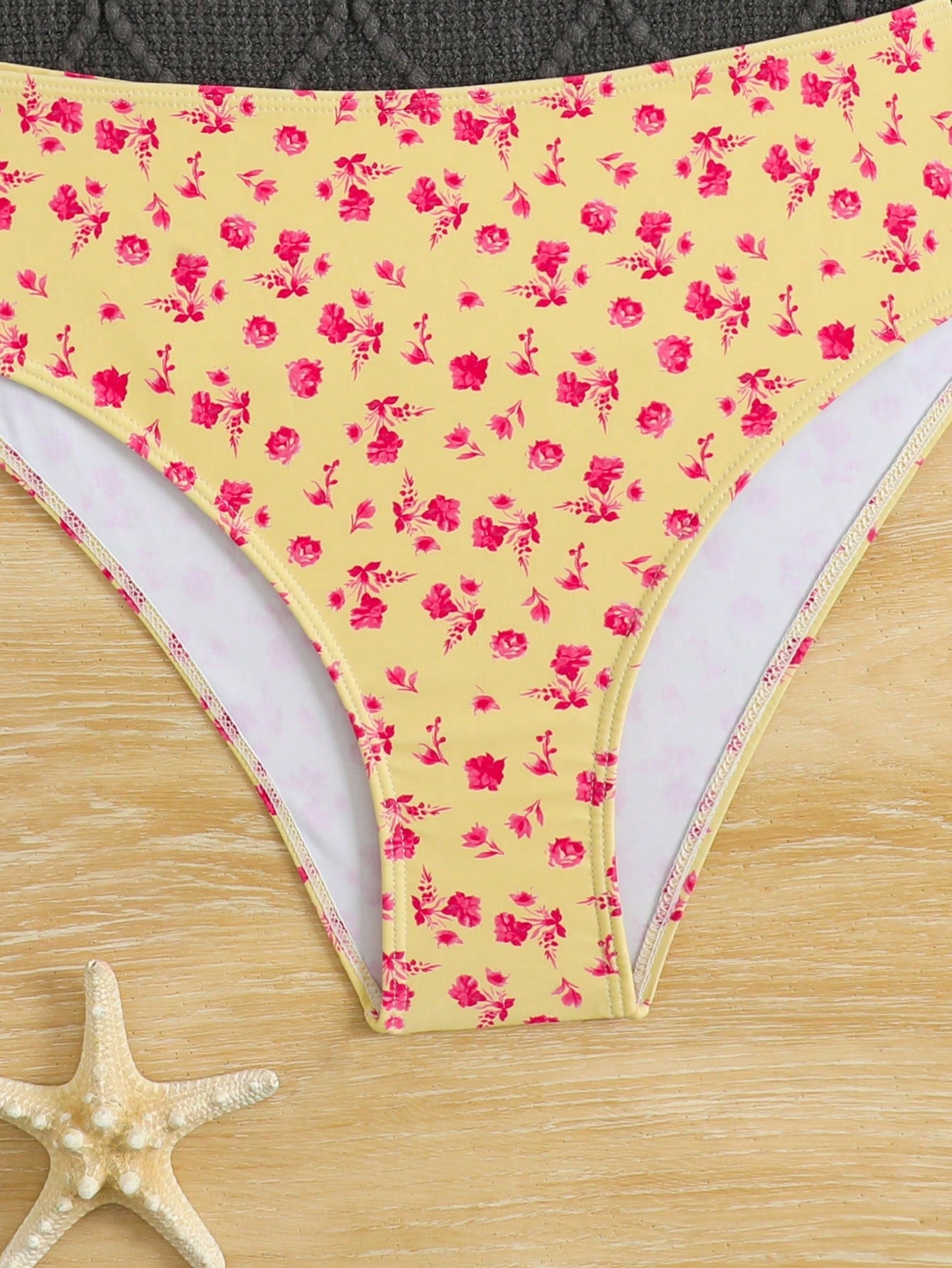 Tween girls 2-piece ditsy floral bikini set featuring a spaghetti strap top with center string detail and matching bottoms with side strings, designed for swimming, vacation, and summer wear.
