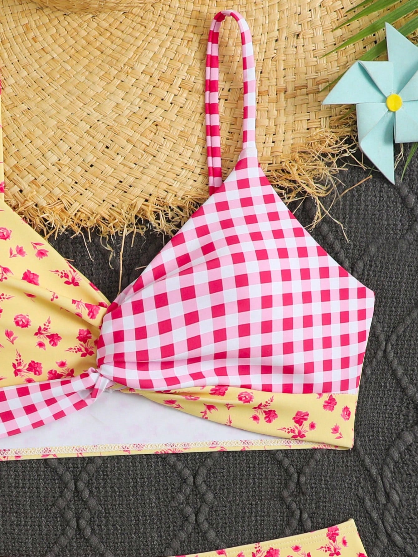 Tween girls 2-piece ditsy floral bikini set featuring a spaghetti strap top with center string detail and matching bottoms with side strings, designed for swimming, vacation, and summer wear.