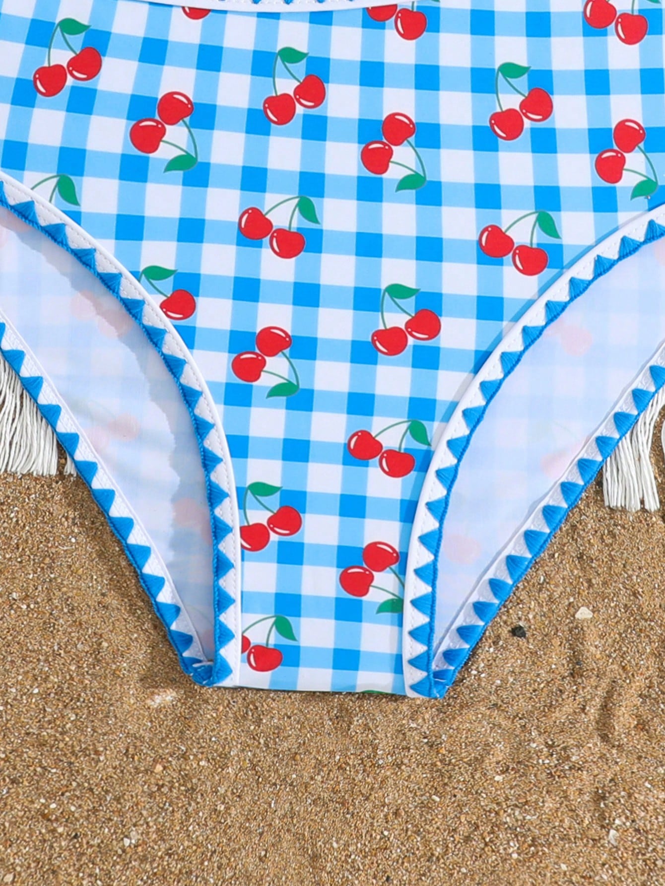 Tween girls one-piece swimsuit featuring an asymmetric neckline, pendant decor, plain design, wireless bra, high-cut bottom, and medium-stretch fabric.