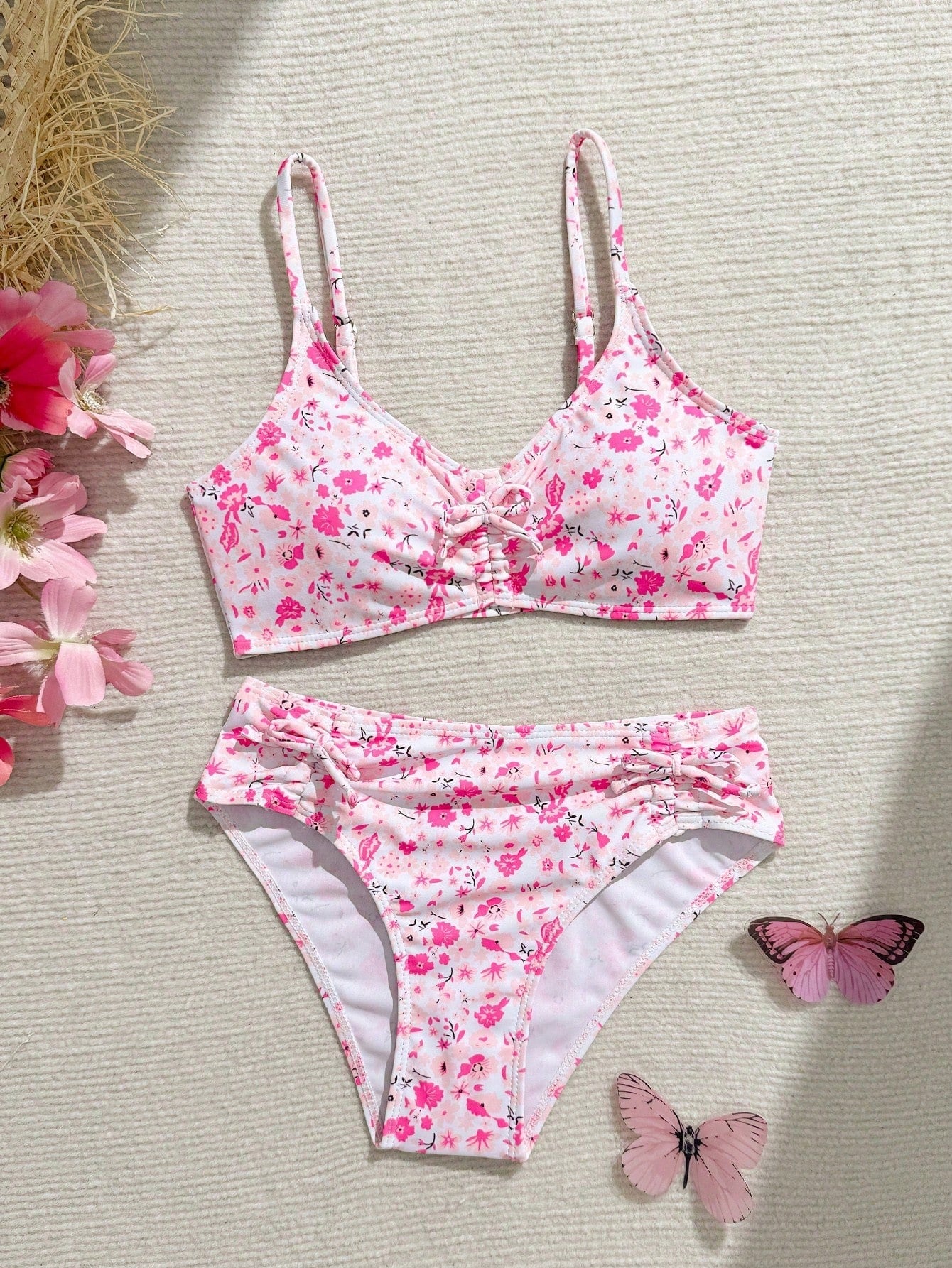 Tween girls 2-piece ditsy floral bikini set featuring a spaghetti strap top with center string detail and matching bottoms with side strings, designed for swimming, vacation, and summer wear.