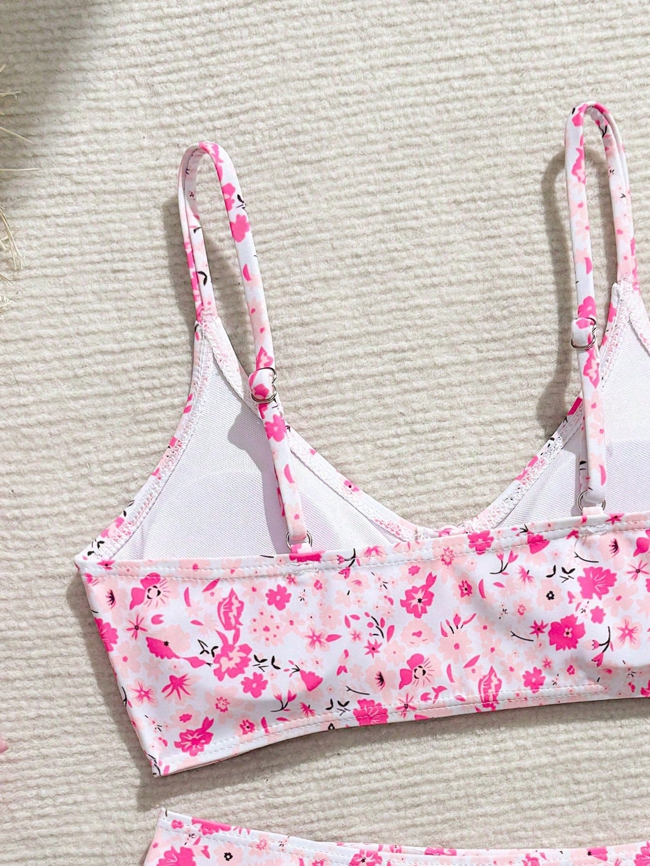 Tween girls 2-piece ditsy floral bikini set featuring a spaghetti strap top with center string detail and matching bottoms with side strings, designed for swimming, vacation, and summer wear.