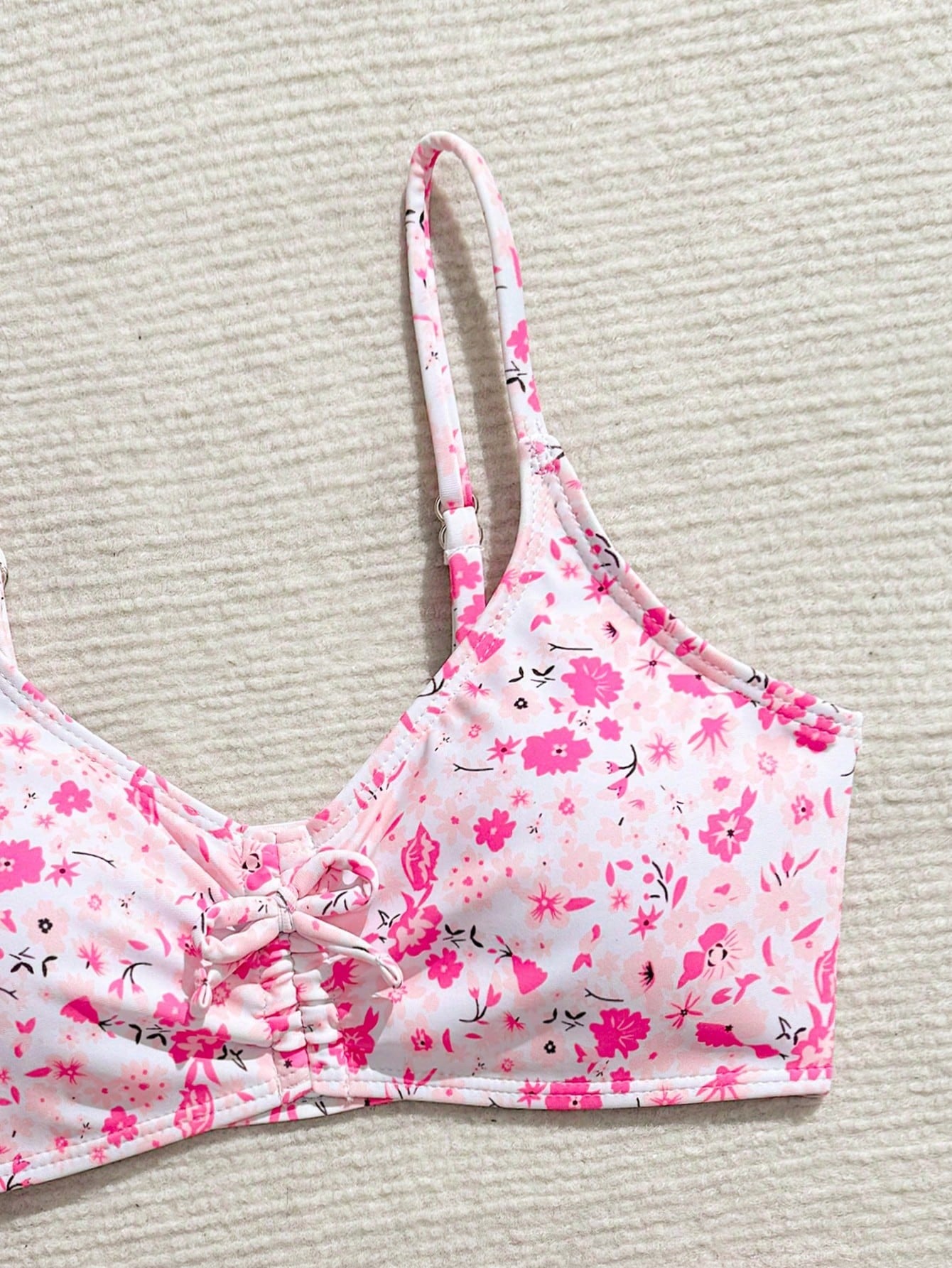Tween girls 2-piece ditsy floral bikini set featuring a spaghetti strap top with center string detail and matching bottoms with side strings, designed for swimming, vacation, and summer wear.