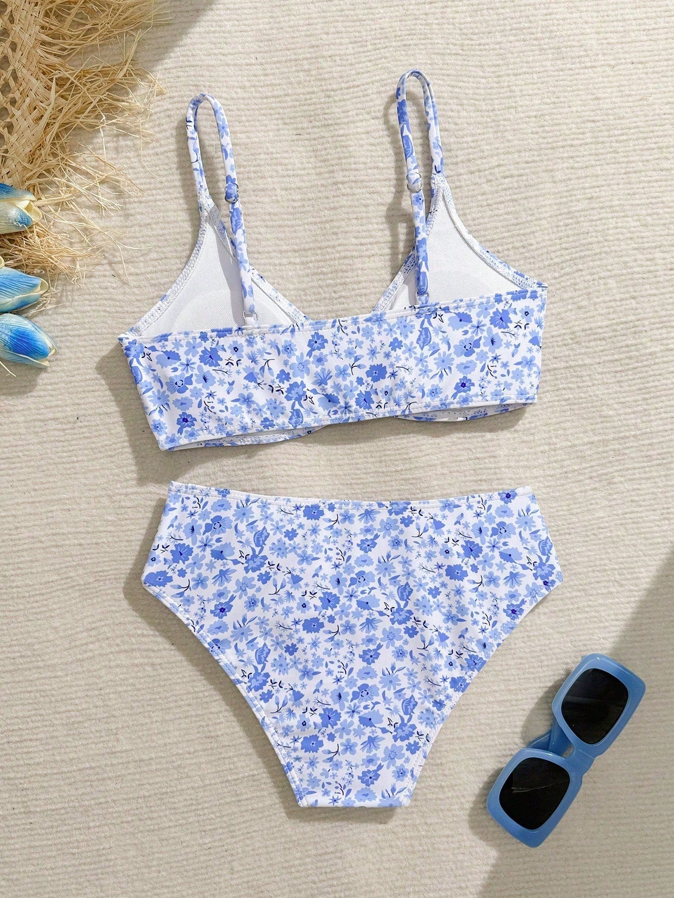 Tween girls 2-piece ditsy floral bikini set featuring a spaghetti strap top with center string detail and matching bottoms with side strings, designed for swimming, vacation, and summer wear.