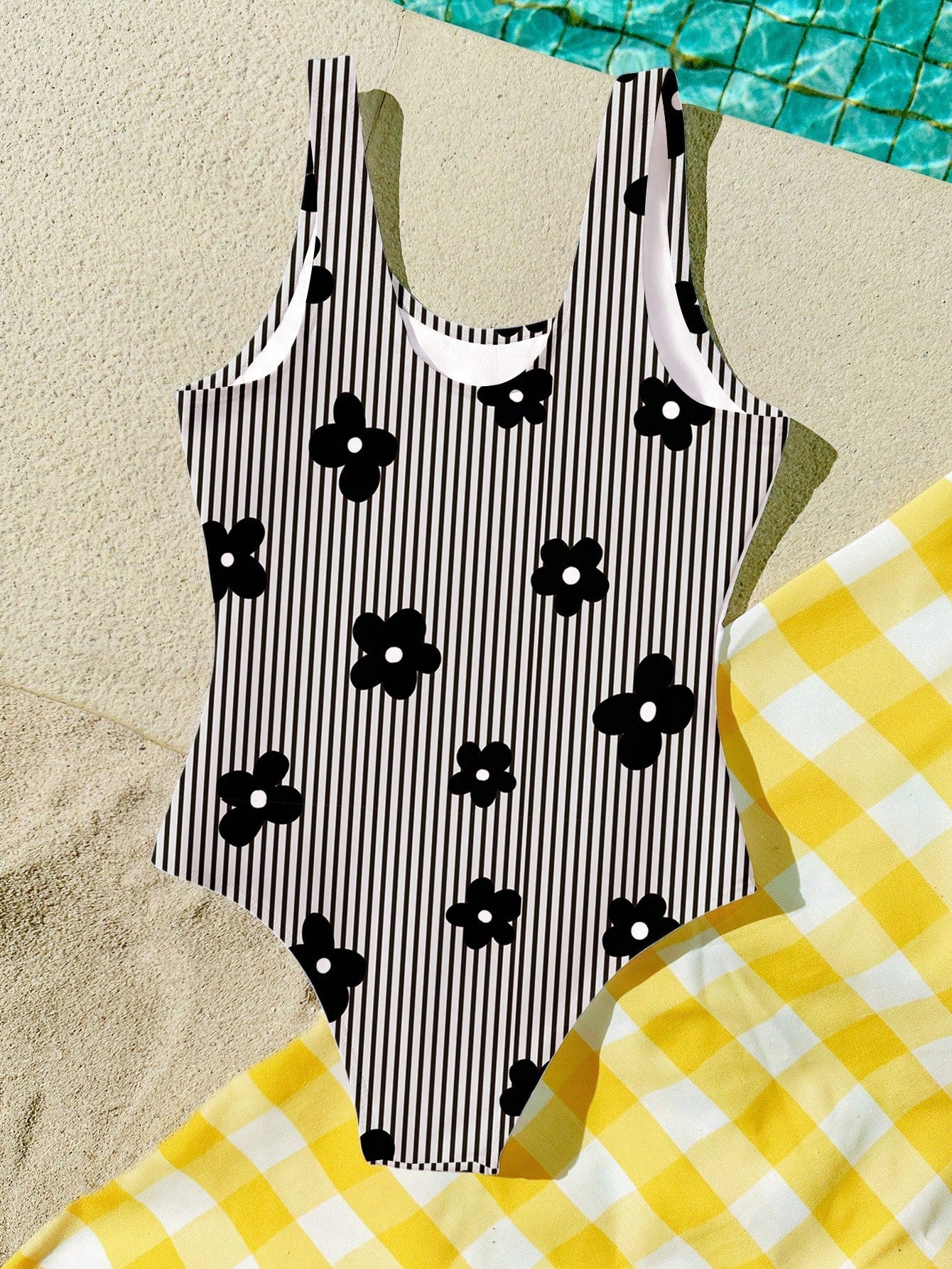 Multicolor tween girls one-piece swimsuit with all-over print, scoop neck, fitted camisole style, and lined body for summer beach vacations.