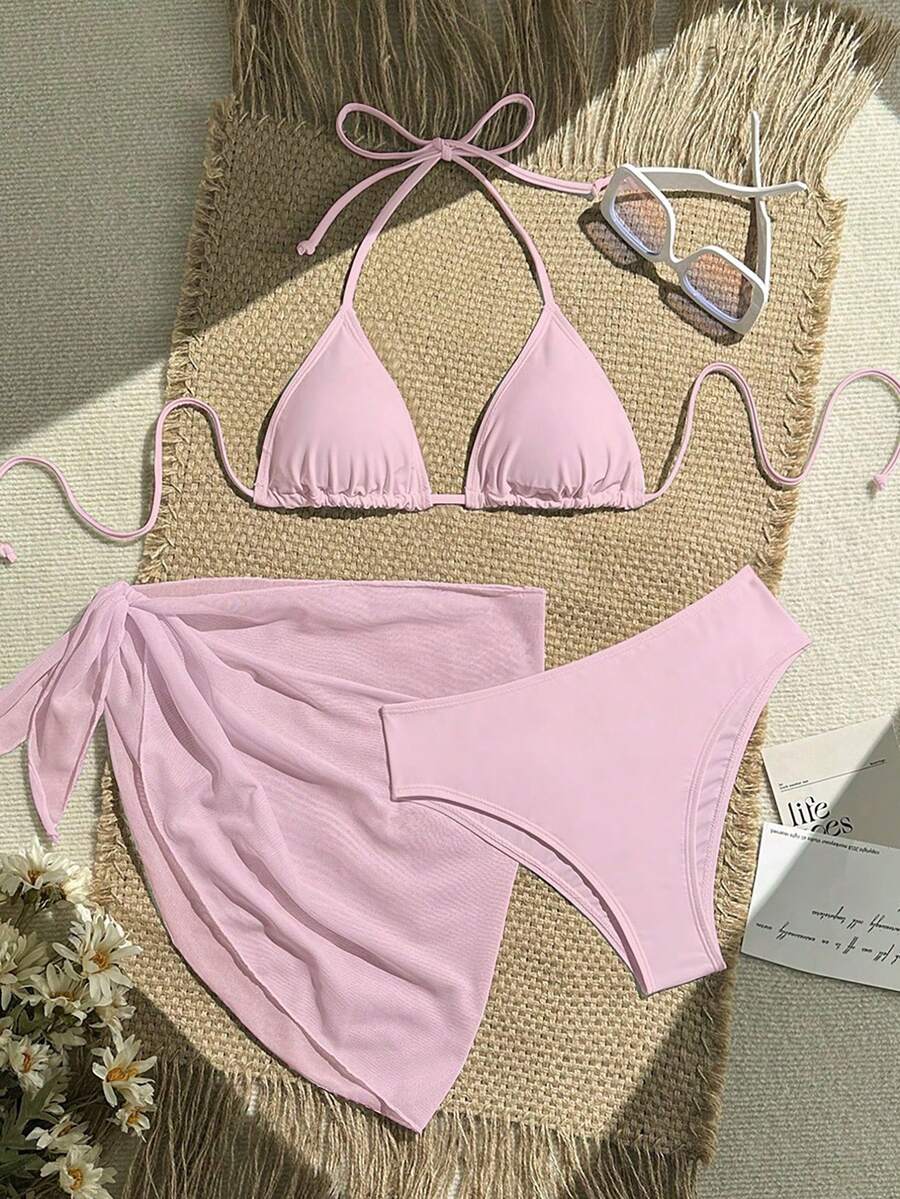 Pink 3-piece boho bikini set featuring a wireless triangle halter top with knot lace up detail and high waist bikini bottoms with matching skirt.