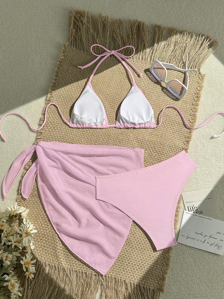 Pink 3-piece boho bikini set featuring a wireless triangle halter top with knot lace up detail and high waist bikini bottoms with matching skirt.