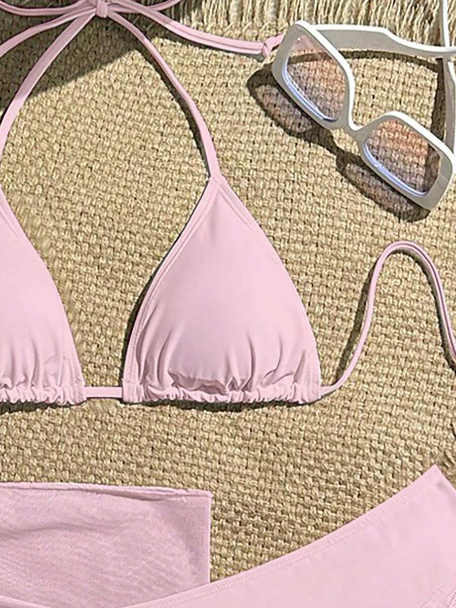 Pink 3-piece boho bikini set featuring a wireless triangle halter top with knot lace up detail and high waist bikini bottoms with matching skirt.
