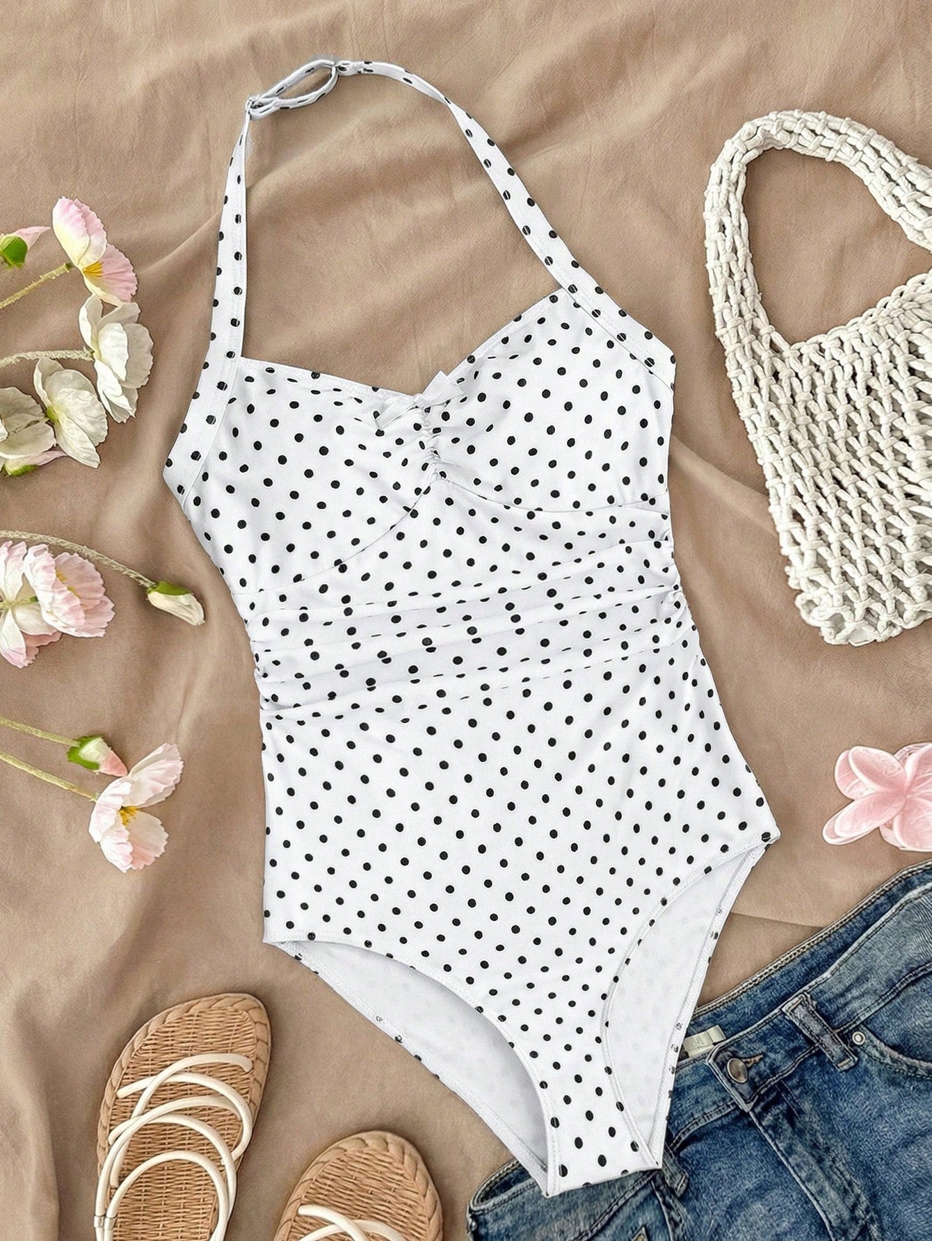 Tween girls one-piece swimsuit with polka dot-inspired all-over print, bow detail, spaghetti strap halter neckline, and lined stretch fabric for beach or vacation wear