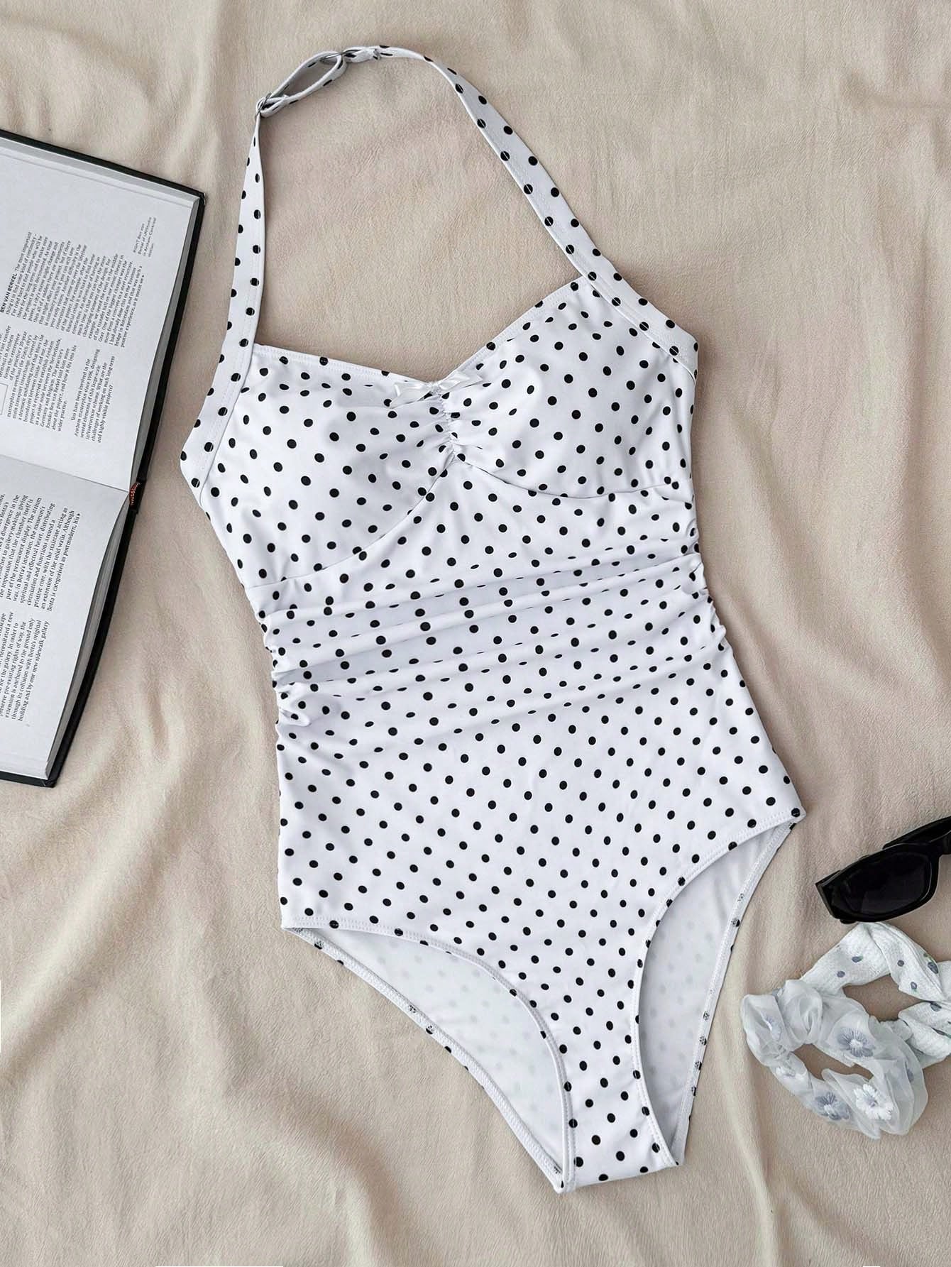 Tween girls one-piece swimsuit with polka dot-inspired all-over print, bow detail, spaghetti strap halter neckline, and lined stretch fabric for beach or vacation wear