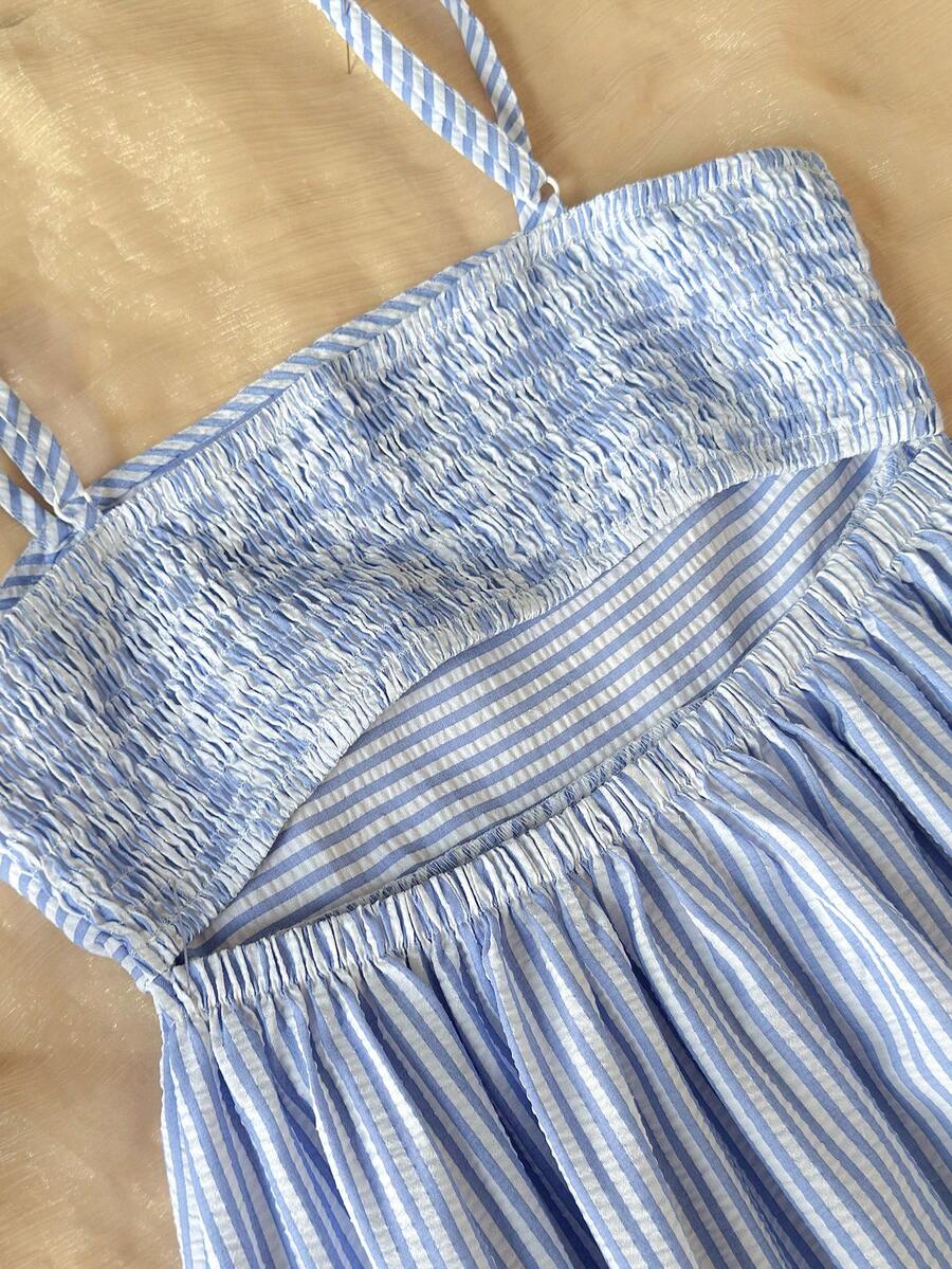 Tween girls blue striped summer camisole dress featuring spaghetti straps, high waist, flared hem, and back zipper detail.