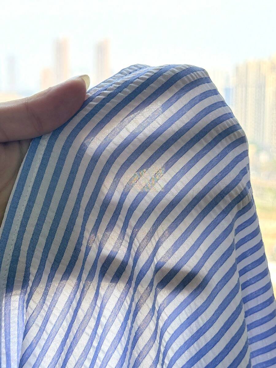 Tween girls blue striped summer camisole dress featuring spaghetti straps, high waist, flared hem, and back zipper detail.