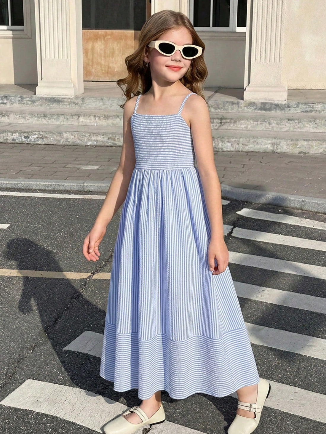 Tween girls striped spaghetti strap cami dress with high waist, shirred detail, zipper closure, sleeveless design, and flared long A-line silhouette for vacation wear.