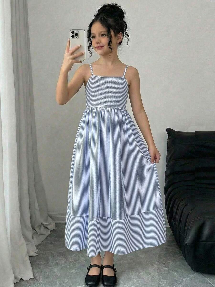 Tween girls blue striped summer camisole dress featuring spaghetti straps, high waist, flared hem, and back zipper detail.