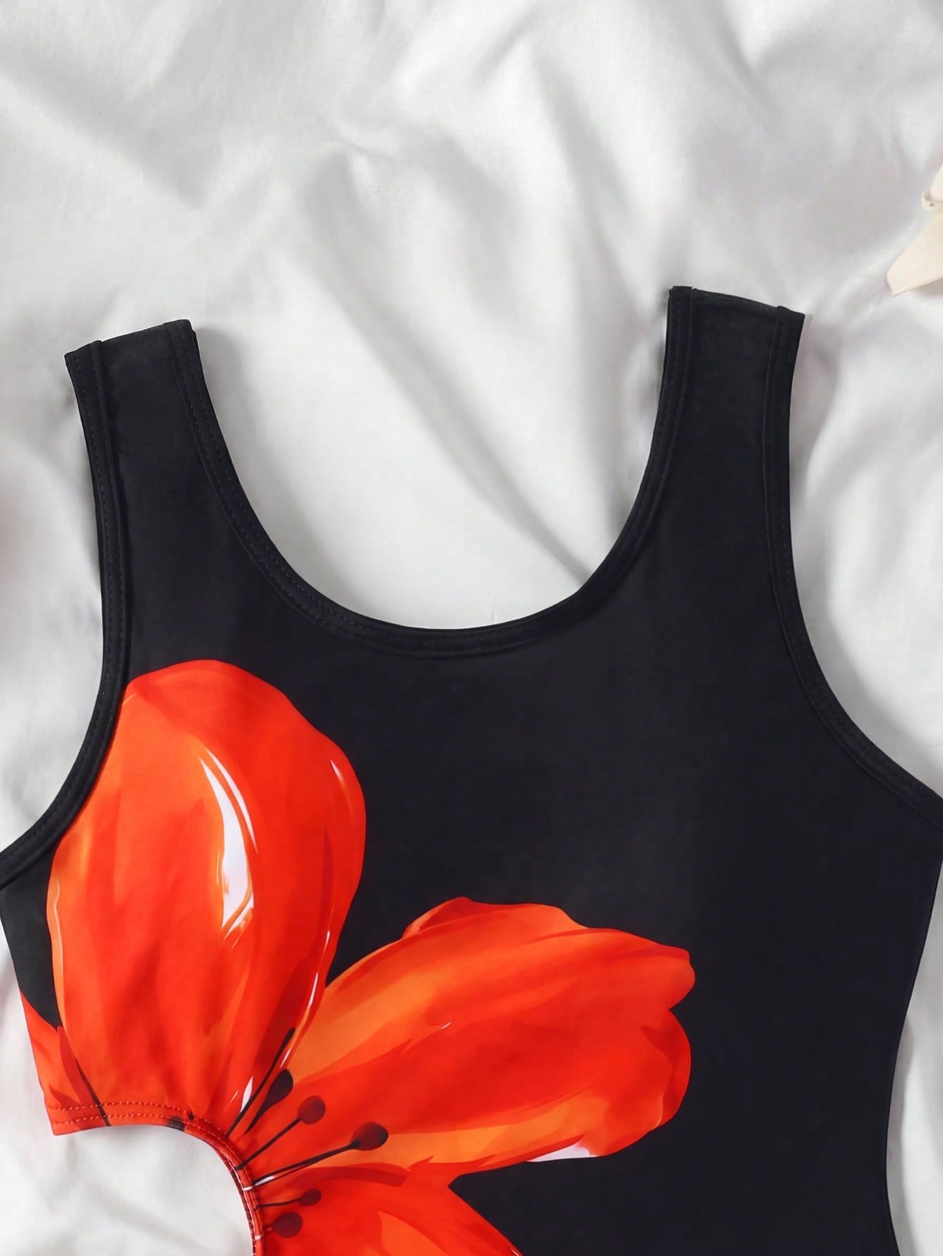 Tween girls' black and white one-piece swimsuit with striped patchwork design, scoop neck, asymmetrical cut-out detail, and fitted vacation swimwear style.