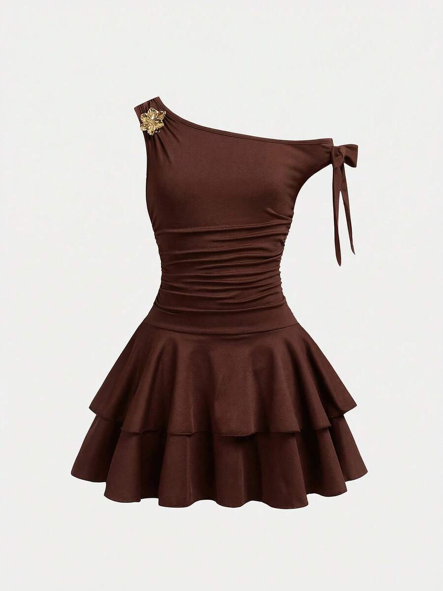 Tween girl wearing an apricot asymmetrical tiered sleeveless party dress with an A-line silhouette.