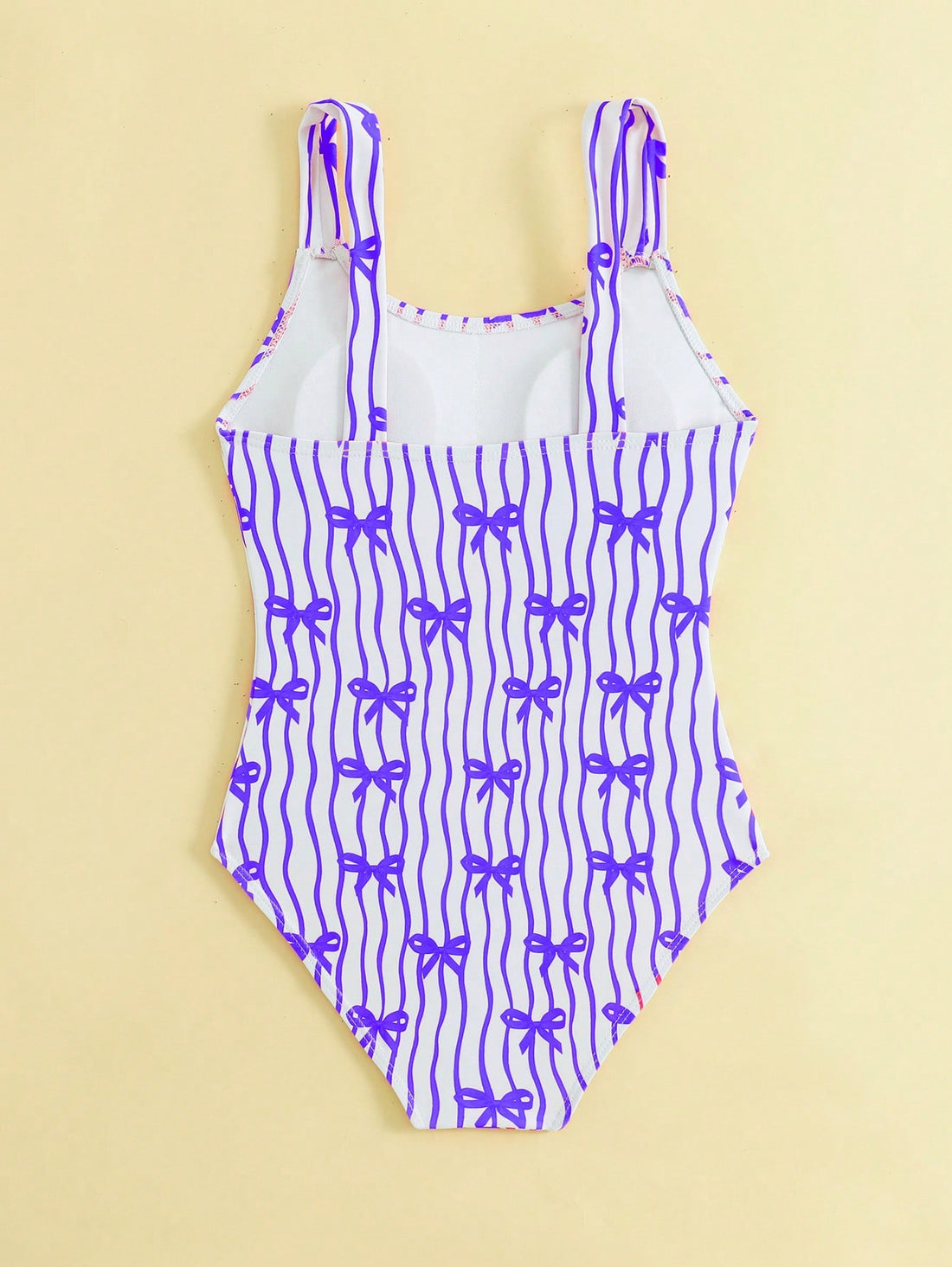 Tween girls one-piece swimsuit in mauve purple with all-over print, spaghetti straps, short length, and vacation swimwear style for beach, pool, and summer swimming.