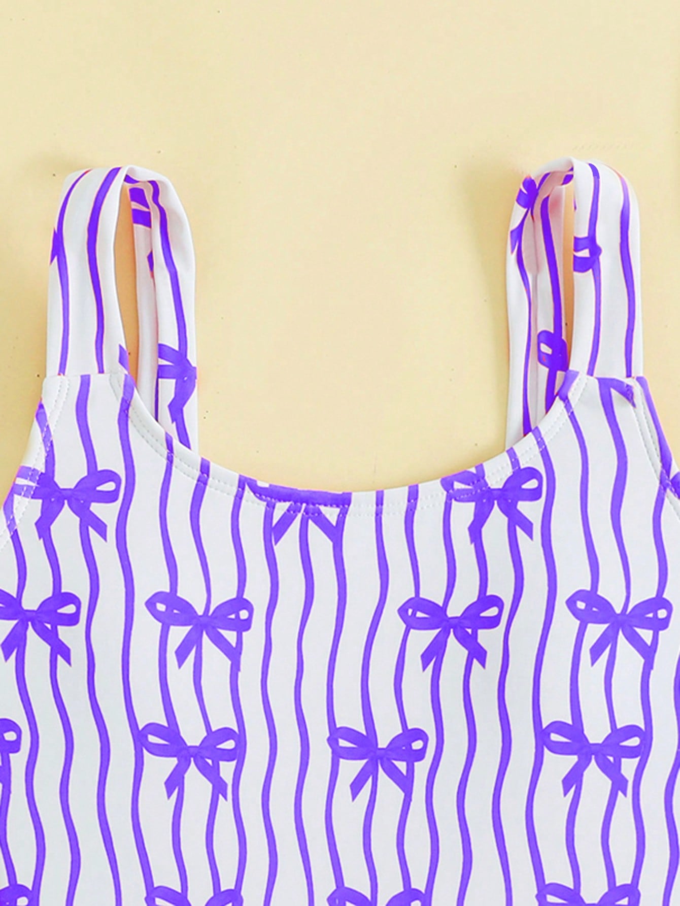 Tween girls one-piece swimsuit in mauve purple with all-over print, spaghetti straps, short length, and vacation swimwear style for beach, pool, and summer swimming.
