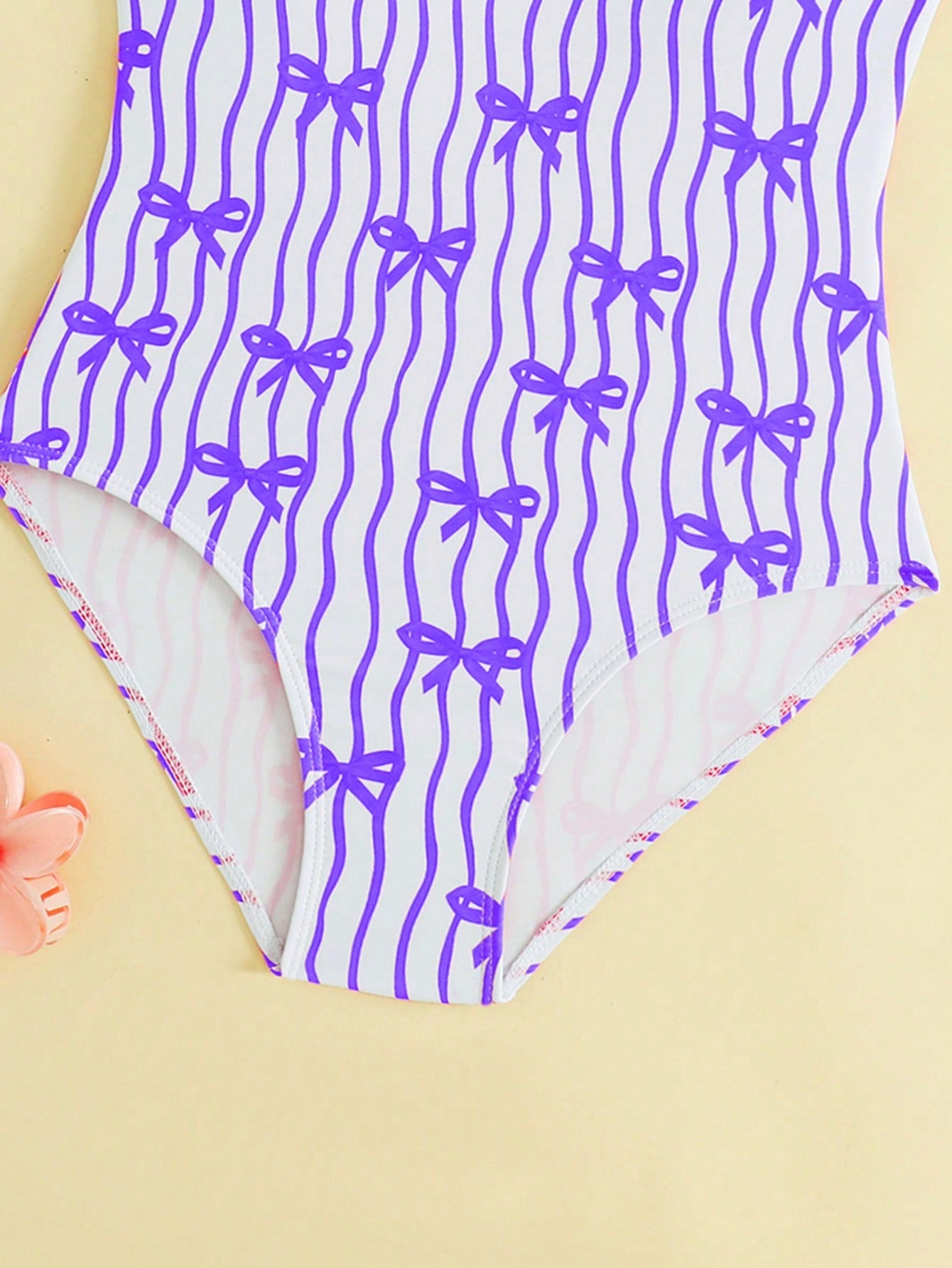 Tween girls one-piece swimsuit in mauve purple with all-over print, spaghetti straps, short length, and vacation swimwear style for beach, pool, and summer swimming.