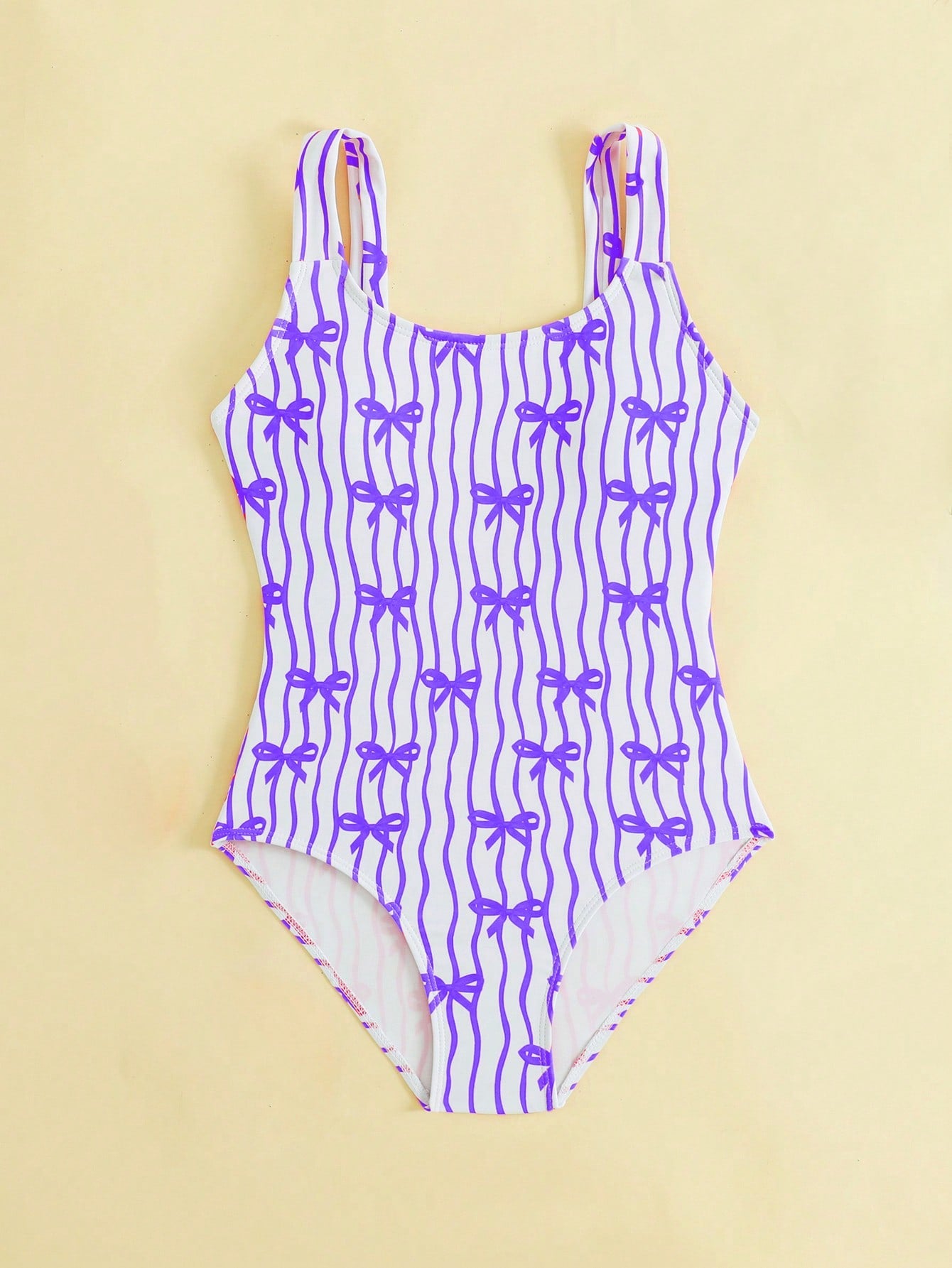 Tween girls one-piece swimsuit in mauve purple with all-over print, spaghetti straps, short length, and vacation swimwear style for beach, pool, and summer swimming.